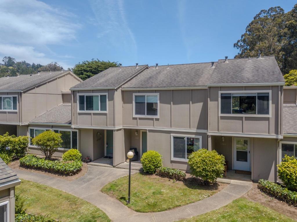Welcome to this desirable 3-bedroom, 2.5-bathroom townhome in the highly sought-after Creekside of Pacifica community. Boasting 1,380 sq ft of freshly painted interior space, this inviting home offers a seamless blend of comfort and functionality. The main level features an open-concept layout with a kitchen, dining area, and spacious living room all enhanced by beautiful engineered bamboo flooring and double-paned windows. A convenient half bath and a full-sized washer/dryer with ample storage in the utility room add to the homes everyday ease. Upstairs, enjoy stunning views of tree-lined hills from all three bedrooms, creating a peaceful retreat. The private, fenced back patio is perfect for outdoor dining, BBQs, or casual gatherings. An assigned carport space is just steps from your door for added convenience. Ideally located just a short walk to San Pedro Valley Park, offering scenic hiking trails, and close to the community pool this home is your gateway to both nature and neighborhood charm.