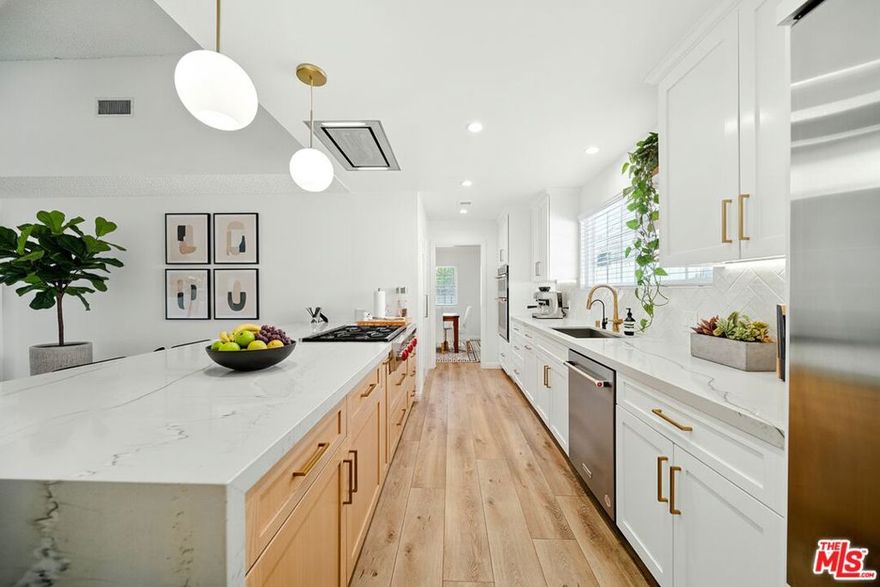 Nestled in the prestigious Highlands of Granada Hills, this beautifully updated single-story home offers 5 bedrooms and a thoughtful floor plan designed for both comfort and style. A skylight and expansive sliding doors fill the living room with natural light, creating a bright, airy gathering space that seamlessly connects indoors and out. The remodeled kitchen serves as the heart of the home, showcasing a spacious walk-in pantry, stunning waterfall countertop, and premium stainless steel appliances including a double oven and Wolf gas range. The primary suite offers a peaceful retreat with a walk-in closet and a fully renovated ensuite bathroom featuring a smart mirror and modern finishes. The second bathroom has also been recently renovated with stylish upgrades. Four additional bedrooms provide flexibility for family, guests, or a home office. Step outside to a serene backyard with a covered patio and fruit trees yielding tangerines, grapefruit, and sweet lemons - perfect for relaxing or entertaining. Recent upgrades, including dual-pane windows, plumbing and sewer line improvements, and a newer roof and A/C system, highlight the home's exceptional care and quality. Located near Knollwood Country Club, O'Melveny Park, and top-rated schools such as Van Gogh Charter Elementary and Robert Frost Middle, this home beautifully combines lifestyle, location, and value into one outstanding offering.