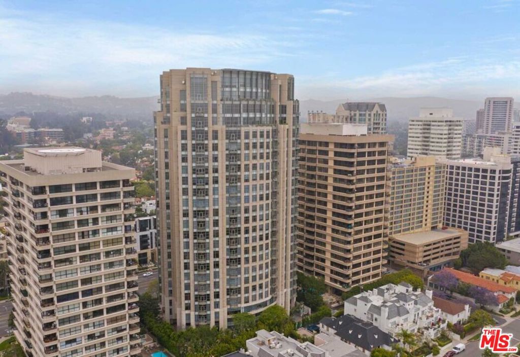 Remodeled living room and kitchen, Carlyle Residency, a 24-story high-rise at the west end of the Wilshire Corridor, known as the Golden Mile. This magnificent residence boasts 2 Bedrooms, 2.5 Bathrooms, a versatile Den/Office convertible to a 3rd Bedroom, luxury with 24/7 concierge services, exclusive private foyer elevators, an indulgent immersion pool and state-of-the-art fitness center, luxurious club room and private dining area, majestic grand lobby, personal valet parking service, & cutting-edge security. a private storage unit, and a personal wine locker.