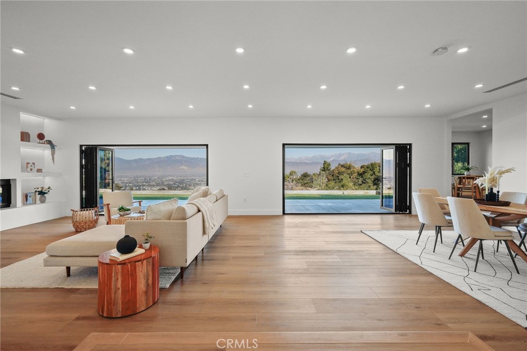 Experience elevated living in this stunning, meticulously renovated custom estate tucked away in the prestigious South Hills of Covina. Designed for those who value precision, privacy, and effortless luxury, this 4-bedroom, 3-bath home rests on nearly an acre of gated, horse-zoned land with sweeping views of the San Gabriel Valley. Every element has been thoughtfully curated; from the chef’s kitchen outfitted with Wolf, JennAir, and Thermador appliances to the tranquil spa-style bathrooms featuring LED mirrors and frameless glass enclosures. A striking 8-foot modern fireplace anchors the main living space, enhanced by wide-plank hardwood flooring, and custom built in shelving. The expansive bi-fold doors create for seamless indoor-outdoor flow, ideal for relaxation or elegant entertaining. Smart home features, including a Nest thermostat, full media wiring, and a video doorbell, offer both convenience and security, while new plumbing, a 200-amp electrical panel, a tankless water heater, and a new cool roof ensure peace of mind and long-term efficiency. Surrounded by custom landscaping and ambient lighting, this serene, move-in-ready retreat is the perfect balance of luxury, comfort, and refined living. An ideal sanctuary for the modern professional.