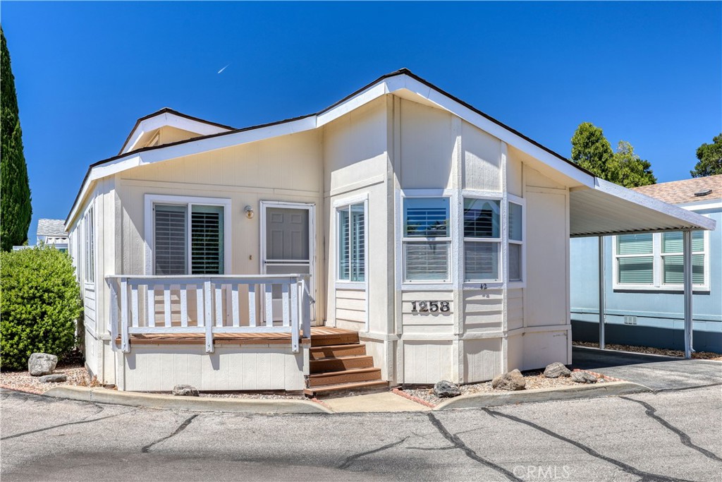 Nestled on a spacious corner lot, this 2 bedroom, 2 bath 1,043 sq ft manufactured home offers comfortable senior living in a prime location just minutes from Downtown Atascadero. Situated near the clubhouse and guest parking, this residence combines convenience with community amenities. Step inside to a bright and airy living room featuring vaulted ceilings, skylights, and plantation shutters. The open layout flows seamlessly into the dining area and kitchen, perfect for entertaining or everyday living. The primary suite includes an ensuite bath with dual sinks and a walk-in shower. A second bedroom provides easy access to a full hall bath—ideal for guests or office space. Additional highlights include a dedicated laundry room off the kitchen, a welcoming front deck, a carport with ample parking, and a storage shed. Enjoy the convenience of being close to restaurants, unique shopping, and entertainment in downtown Atascadero, all within a serene and well-maintained 62+ community.