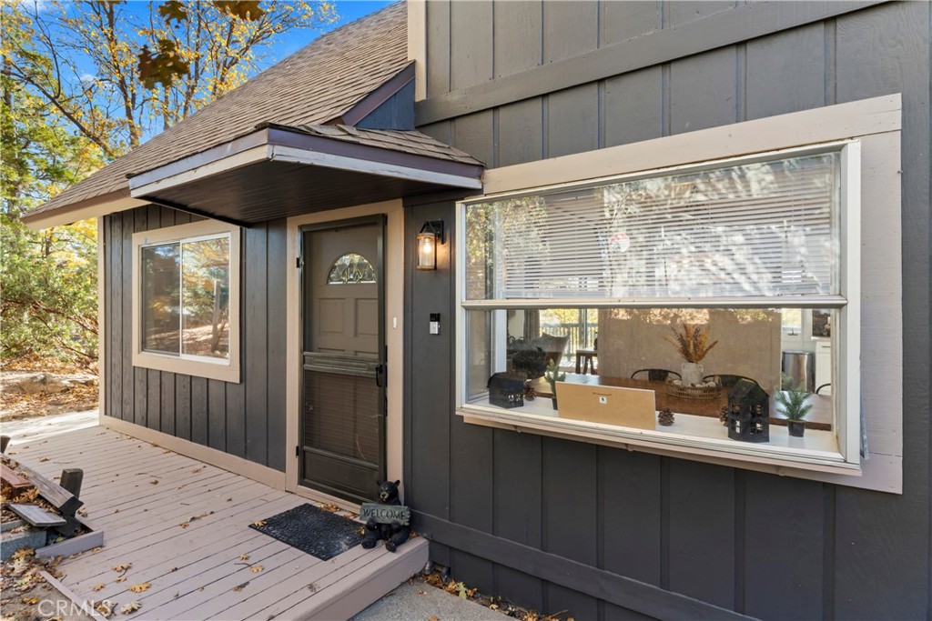 Gorgeous Lake Arrowhead retreat with coveted lake rights. This turnkey, fully furnished 4-bedroom, 3-bath residence sits on a private corner lot and showcases vaulted ceilings that fill the home with light. The main level features a breathtaking family room with a cozy fireplace, an open kitchen and dining area that flows seamlessly outdoors, and convenient main-level laundry. Step outside to an expansive patio deck with a spa, perfectly positioned to capture beautiful mountain views and the serenity of the pines. With an attached garage, parking for four vehicles, and abundant privacy, this home is ideal for a big family, weekend hosting, or a peaceful full-time retreat. Enjoy the ultimate Lake Arrowhead lifestyle with exclusive lake rights for boating, swimming, and lakeshore relaxation, all in a tranquil and inviting setting.
