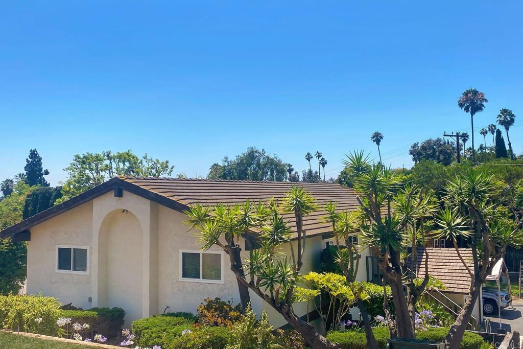 This is the Vista home you've been waiting for. Picture a stunning split level ranch sitting on a massive 10,700 sq ft lot in one of Vista's most desirable neighborhoods. This gorgeous 4 bedroom, 2.5 bathroom home offers 2,127 sq ft of thoughtful living space with NO HOA restrictions and plenty of room to breathe, play, and grow! When you pull up, you'll be amazed by the spectacular curb appeal. Mature yucca trees and vibrant agapanthus blooms create beautifully manicured landscaping that will make you fall in love before you even step inside. The covered entry and thoughtful design details really make this home stand out on the tree lined street. Inside, you'll discover smart split level living with a massive room downstairs with a beautiful wood burning fireplace. It's Ideal for an ADU or mother in laws unit with an additional entry and parking which is perfect for all ages. The thoughtful floor plan flows beautifully with a main level separate family room, formal dining room, and three convenient primary suites. The backyard is absolutely incredible! Nearly 11,000 sq ft of pure potential with mature shade trees providing natural beauty while the flat, usable space offers endless possibilities for pools, gardens, play areas, or whatever your heart desires. There is room to add an additional ADU and RV parking. This is what California outdoor living is all about! You'll also love the 2 car attached garage plus extra parking, R1 zoning, and public utilities. The location couldn't be better in this established neighborhood with tree lined streets. You get the best of suburban tranquility with urban convenience since you're close to shopping, top rated schools, and freeway access. Plus your money stays in your pocket with no HOA fees! Here's the scoop on timing: We're going active with no showings for two weeks. Showings begin August 2nd and we have more professional interior photos coming soon! This isn't just another house, it's your Vista sanctuary waiting to happen. The combination of split level convenience, massive lot, gorgeous landscaping, and prime location doesn't come around often. When it does, it doesn't last long. Don't let this rare gem slip away because I promise you'll regret it. - Laundry hookups present inside, confirm configuration (closet vs. room). Dryers not included. NOTE: All Information deemed reliable but not guaranteed. Buyer and Buyer’s agent must verify.