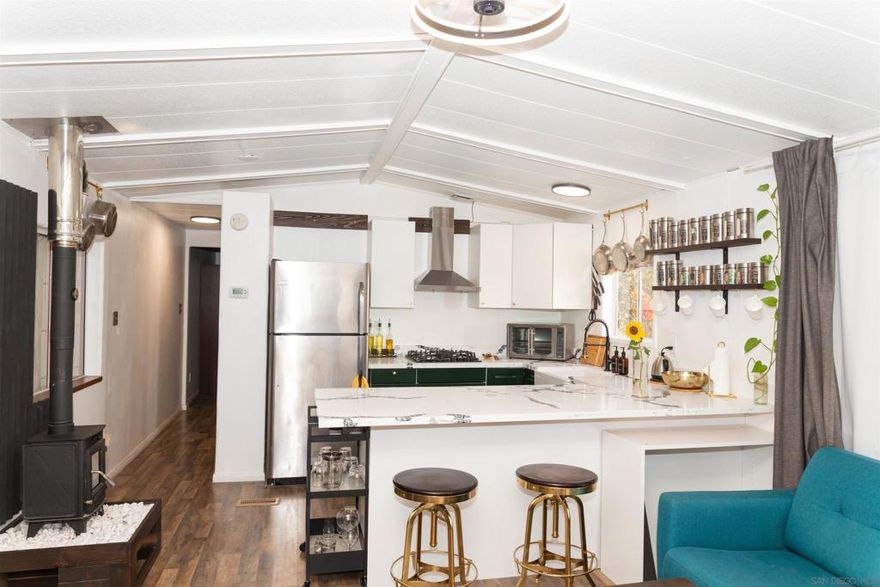 Price improvement!!  Private retreat in historic Cuca Ranch, nestled on a fully fenced 3.58-acre parcel with sweeping views of the Palomar Mountains. This versatile property is perfectly set up for equestrian living, peaceful country getaways, and income generation—all in one. In the past four years, the property has undergone a complete transformation through substantial upgrades, carefully planned additions, and extensive rehabilitation through hard work and over hundred thousand in capital investment. The recently remodeled 500 sq. ft manufactured home offers cozy living with modern comforts, backed by a well and 5,000-gallon storage tank, 200-amp SDG&E power, and a septic system installed for a future 3-bedroom, 2-bath expansion. Equestrian features include 4 covered horse stalls with an adjoining hay storage area, a regulation-size horse arena, and plenty of open space to ride and roam.  Additional improvements include: 1) 40-foot shipping container for secure storage  2) Metal-roofed workshop area with a concrete pad—ready for your tools or creative projects 3) Multiple outbuildings offering endless possibilities for use or development 4) For those looking to generate income, a well-established Airbnb motorhome on-site brings in consistent revenue with 30+ five-star reviews.  Whether you're dreaming of a horse property, a mountain escape, or a flexible investment opportunity, this rare find in Cuca Ranch is ready to deliver.