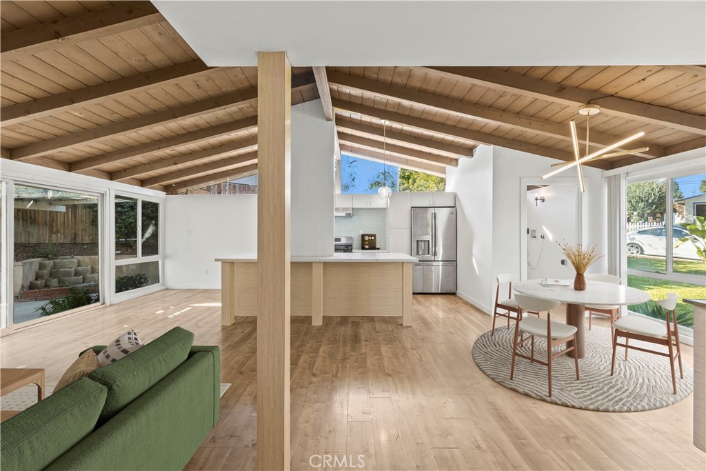 A stunning mid-century post-and-beam home that seamlessly blends timeless design with modern comforts. Thoughtfully renovated, this residence honors its architectural heritage while offering the conveniences of contemporary living. Expansive windows fill the space with natural light, influencing the carefully curated color palette and cohesive design throughout.
At the heart of the home is a beautifully appointed kitchen, featuring sleek, European-inspired flat-panel cabinetry paired with modern tile accents and clean, minimalist lines. A spacious 8-foot island anchors the space, making it the perfect gathering spot for family meals and entertaining.
Bright, custom laminate flooring extends through the kitchen, living, dining, and bedroom areas, creating a warm and cohesive flow. The bathrooms echo the home’s overall design — light, refined, and thoughtfully styled with a modern touch.
Both the front and back yards are professionally landscaped, enhancing the home’s curb appeal and offering serene outdoor living spaces.
Located just a short walk from the sought-after La Mirada Regional Park, this home offers unmatched access to amenities including a 1.5-mile walking trail, 27-hole golf course, playgrounds, fishing spots, gymnasium, sports courts, and picnic areas. Also nearby is Splash! — a vibrant aquatic center featuring Buccaneer Bay, perfect for family fun all summer long.