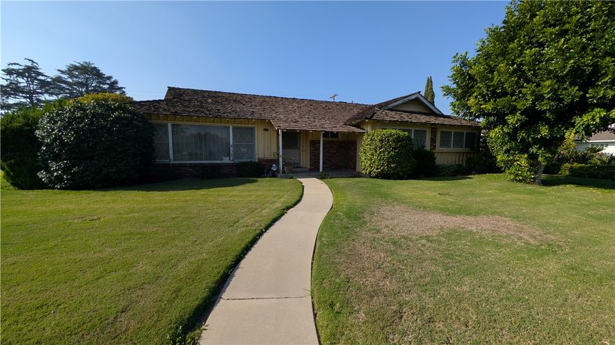 Great property in Northeast Downey.  Corner lot, abundance of features and benefits.  This house has it all.  Formal entry area with tile flooring, Wet bar nearby, Formal Living Room, or potential Formal Dining Room, separate large sized Family Room with fireplace, including a skylight and cathedral ceilings.  Permitted enclosed living area patio with direct access to backyard, including a brick fireplace, and next to separate private office.  Good size kitchen with a lot of cabinets, and tile counter top.  Built-in 4 burner range, double oven, and Amana dishwasher.  Separate dining area next to kitchen, including ceiling fan, built-in China cabinet, and a wainscot finish.    Large sized service room, including a basin tub, linen closet, and 3/4 bath, leads to backyard breezeway, 2 car detached garage, and large backyard. Possible RV parking area with concrete flooring, including wrought iron gate on opposite side of detached garage. Other exterior features include sprinklers front and back, side garden area, partial rain gutters, cement pad for A/C unit, and painted block wall on the perimeter.  Hallway inside with an abundance of large storage cabinets.  Bedroom 1 with a built-in large closet, bedroom 2 with a built-in desk and cabinets, along with large built-in closet. Very large Master bedroom and bath including powder room area, 3 closets, and direct access to backyard.  This house is in its original condition, and is filled with all the features and benefits you can think of.