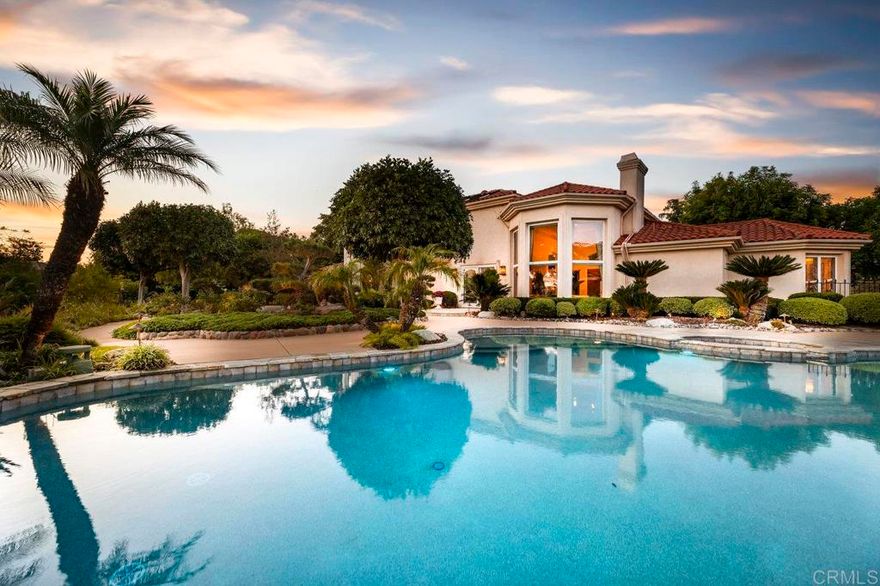 Welcome to your own 1.32 acre resort with large pool plus beach entry, hot tub, sport court, large koi pond, 40 electric solar panels, pool heating solar, garden, fruit trees, sunset views, and plenty of parking. The 2-story home has had many upgrades throughout. The spacious floorplan has a 20+ foot ceiling in the living room directly in front of the entry, a first floor bedroom suite with full bath, and dining room. The kitchen boasts a Wolf gas cooktop in the center island with hood and sink, a large sink facing the window overlooking the koi pond, separate Subzero refrigerator and freezer, dishwasher, double ovens, 2 hidden double trash drawers, warming drawer, bread baskets to keep bread fresh, a huge walk-in pantry, microwave, and a roll-up hideout for counter appliances. The large breakfast nook leads to the family room with large screen wall-mounted TV. Further past is the gorgeous office edition with beam ceilings and beautiful built-in cabinets. The 4 car garage has ample cabinet and ceiling storage. The elegant stairway to the second floor was remodeled in 2007. There is the primary suite with windows looking out toward the west to northwest to see magnificent sunsets. A large bathroom with steam shower and large tub with views is on the other side of the classy 3-sided fireplace.