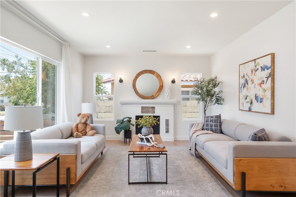 Built in 1929, this reimagined Spanish Bungalow seamlessly blends timeless character with thoughtful modern updates. The front entry opens to a cozy living room and open kitchen, where wide plank vinyl floors and a fireplace create a warm and inviting atmosphere. The kitchen features sleek flat-panel cabinetry, quartz countertops, a matte ceramic tile backsplash, and stainless steel appliances, perfect for both everyday living and entertaining. Off the central hallway, you'll find 3 bedrooms and a remodeled full bathroom. The expansive lot offers exciting potential for future expansion or the addition of an ADU. Additional upgrades include updated plumbing, electrical wiring, newer HVAC system, dual-pane windows, refreshed fencing, new decking, and new tankless water heater. Ideally located in the heart of Harbor City and within walking distance to Harbor City Elementary School, this turnkey home offers a rare blend of character, comfort, and opportunity.