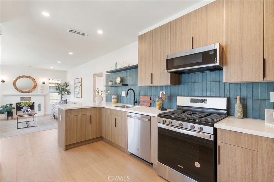 Built in 1929, this reimagined Spanish Bungalow seamlessly blends timeless character with thoughtful modern updates. The front entry opens to a cozy living room and open kitchen, where wide plank vinyl floors and a fireplace create a warm and inviting atmosphere. The kitchen features sleek flat-panel cabinetry, quartz countertops, a matte ceramic tile backsplash, and stainless steel appliances, perfect for both everyday living and entertaining. Off the central hallway, you'll find 3 bedrooms and a remodeled full bathroom. The expansive lot offers exciting potential for future expansion or the addition of an ADU. Additional upgrades include updated plumbing, electrical wiring, newer HVAC system, dual-pane windows, refreshed fencing, new decking, and new tankless water heater. Ideally located in the heart of Harbor City and within walking distance to Harbor City Elementary School, this turnkey home offers a rare blend of character, comfort, and opportunity. Given the recent rate reduction, Please inquire about our seller-assisted rate buy-down that can further enhance your purchasing power and monthly affordability.