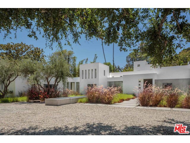Inspired by the work of Ricardo Legorreta this recently re-envisioned architectural masterpiece has been finished inside and out with exquisite taste and attention to detail. Sited on a rare flat 3/4 acre of refined landscaping in a prime location, this warm sophisticated home breathes calm and tranquility from the moment you enter. Interior and exterior spaces merge seamlessly creating the ultimate California lifestyle. The resort size pool's Zen like serenity draws your eye to the expansive lawns, and beyond to a unique beautiful three story guest house overlooking stalls and grooming area for two horses.