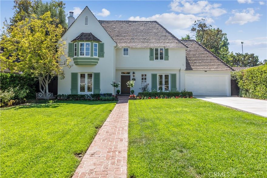 Designed by master architect Roland E. Coate and built in collaboration with esteemed builder Lee S. Davis, this captivating French Normandy-style home is a rare example of early California architectural excellence. Professionally measured at 2,590 sq ft, it combines classic European charm with relaxed indoor-outdoor living, reflecting Coate’s visionary philosophy that “The patio is the heart of the California house,” as noted in House & Garden magazine, 1931.

The home’s graceful composition features steeply pitched rooflines and a soaring 16-foot high-hipped ceiling with exposed wood beams in the formal dining room. The living room centers on a grand fireplace and is framed by multi-pane windows that fill the space with natural light. Every first-floor room opens through French doors to the surrounding gardens, creating seamless indoor-outdoor flow.

Architectural details abound, including arched entryways, crown molding, and crystal chandeliers that enhance the refined character throughout. The floor plan flows effortlessly, balancing open spaces with cozy, intimate areas. Built-in Bluetooth-enabled speakers wired throughout provide an elevated living experience, perfect for entertaining or relaxing. Recent updates include new landscaping, fresh interior and exterior paint, upgraded electrical systems, bathroom mirrors, plumbing, and lighting fixtures (full list available).

Step outside to a private brick terrace framed by manicured gardens and mature trees—an idyllic setting for morning coffee, afternoon reading, or romantic dinners. A thoughtful exit from the family room and kitchen opens to a brick-paved patio, perfect for sunset entertaining and gatherings under the stars.

Upstairs, spacious bedrooms offer serene mountain and garden views. Situated on a generous 9,256 sq ft lot, a new 70-foot concrete driveway provides parking for four vehicles and leads to an attached two-car garage. A 140 sq ft California basement is also included.

This is a rare opportunity to own a piece of architectural history in one of San Marino’s most coveted neighborhoods. The home masterfully blends classic charm with modern comfort and gracious hospitality. Reflecting the enduring legacy of Roland E. Coate, it offers a lifestyle rooted in beauty, tranquility, and timeless appeal. Conveniently located near the Huntington Library, Caltech, and within the award-winning San Marino School District, this exceptional residence is truly a cherished treasure.