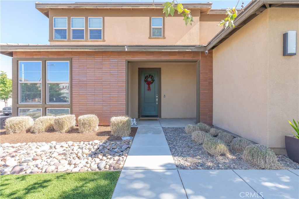 Move-in Ready Home in Desirable Centennial Community! This well-maintained 4 bed + loft, 3 full bath home includes a downstairs bedroom and full bath—perfect for guests or multi-gen living. Spacious open layout with large kitchen, oversized island, quartz counters, walk-in pantry, and stainless farmhouse sink. Upstairs features a loft, large laundry room, and a spacious primary suite with a huge walk-in closet. The backyard is hardscaped and includes a covered California room for indoor/outdoor living. A tandem garage has been partially converted into a studio-style flex room, ideal for a home office, game room, or guest space. Low HOA ($29/mo). Walk to parks and schools. Minutes from shopping, dining, and freeway access!