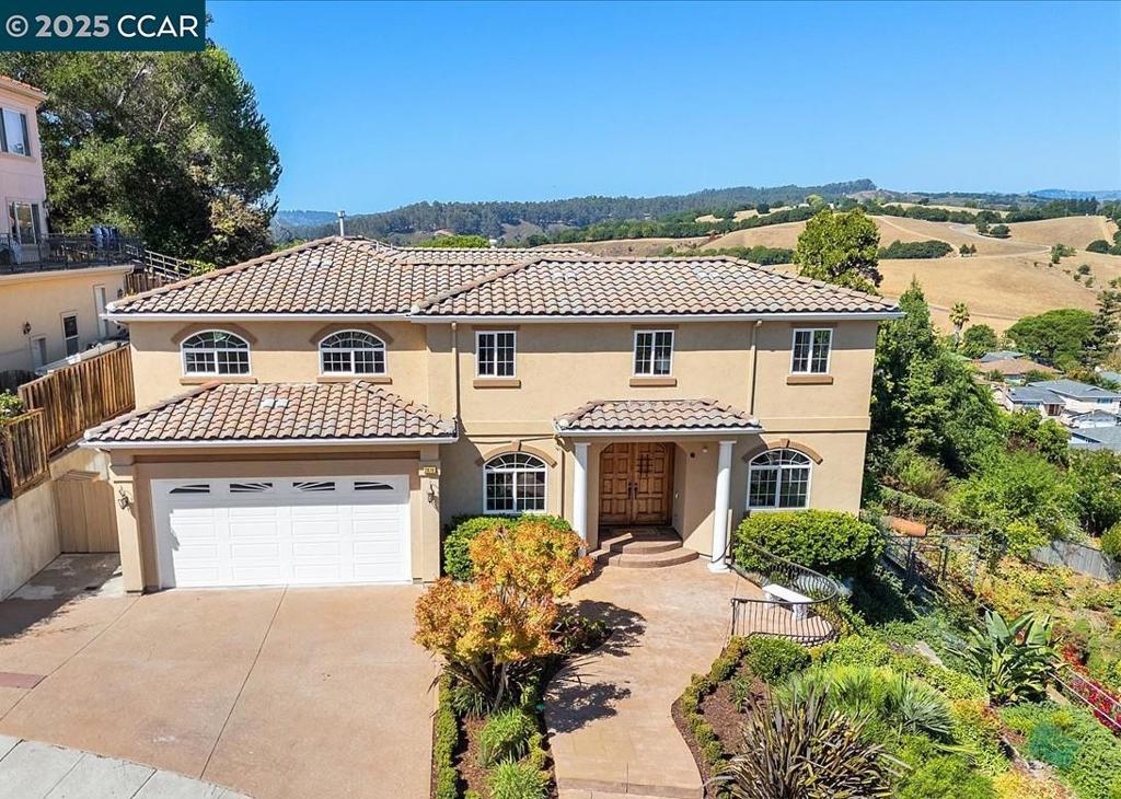Luxury Living w/Sweeping Panoramic Views & Multigenerational Comfort in Exclusive Gated Community. Experience elevated living in this stunning 5-bed, 4-bath custom-built home, showcasing panoramic views from one of Castro Valley’s most prestigious gated enclaves. Perched on a hilltop among 11 custom residences, this home offers 5,200 sq. ft. of thoughtfully designed space—blending functionality, craftsmanship & scenic beauty. Gorgeous double door opens to foyer flooded w/natural light. A private elevator connects both levels for seamless access. Upstairs you will find a large primary w/spa-like bathroom & fireplace. Secondary en-suite plus 3 additional rooms, full hall bathroom & laundry. Downstairs, you will find a dedicated home office w/full bath, adding flexibility as a 5th bedroom, ideal for multi-gen living or extended guests. Gourmet kitchen feats. top-tier appliances, island & ample counter space—perfect for meal prep & festive gatherings. The spacious lower level offers opp. for a 3rd living space, bar area or playroom. Outside, enjoy mature citrus trees & a peaceful backyard w/turf framed by breathtaking hilltop vistas. Oversized tandem three-car garage w/extra-deep storage. Top-rated schools, markets, & major commuter route (I-580). Open 9/20 & 9/21 1:30-4