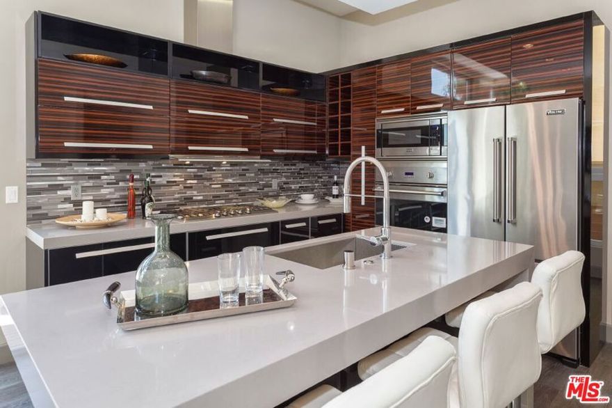 Welcome to your dream home. This new construction contemporary designed smart townhome has been custom designed with the modern resident in mind. This pinnacle of vertical living offers exclusivity and privacy while the prestigious North of Sunset location is only steps away from the best dining, shopping, and entertainment venues in the City! Four stories and serviced by a private in-suite elevator, this one of a kind unit offers supreme privacy and unobstructed 270-degree views of Downtown to Santa Monica. Living and dining room are located on a separate level which features 12ft ceilings, private balcony, floor to ceiling glass walls and windows, open contemporary European designed kitchen with custom edge Quartz Stone countertops, center island, built-in professional series stainless steel Viking Appliances. Spacious master bedroom, huge custom designed master closet with organizers. *Photos of model staged unit, listed unit has varying finishes and layout.