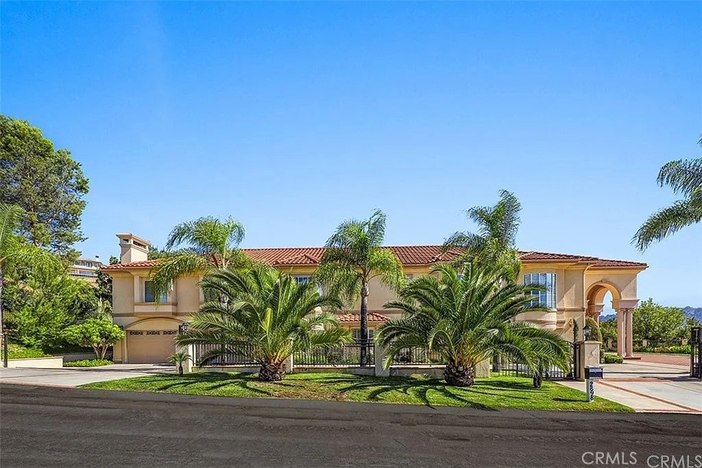 Welcome to this beautifully designed, elegant custom-built estate in the prestigious 24-hour guard-gated community of The Country Estates' community. This spacious two-story mansion features 5 bedroom suites plus a powder room, including one suite on the main level. Highlights include a gourmet kitchen with granite countertops and built-in appliances, soaring ceilings, custom draperies, crystal chandeliers, and a grand library with built-in shelving. Enjoy multiple living spaces, a luxurious primary suite with dual walk-in closets, a spa-like bath with steam shower and Jacuzzi tub, and a beautifully landscaped backyard with a fountain. The property also has a gorgeous movie theater room. Located on a quiet cul-de-sac with a private gated driveway, 3-car garage, and 3-zone central AC for year-round comfort. Phenomenal location affording utmost privacy with stunning surrounding views. Come see and appreciate!