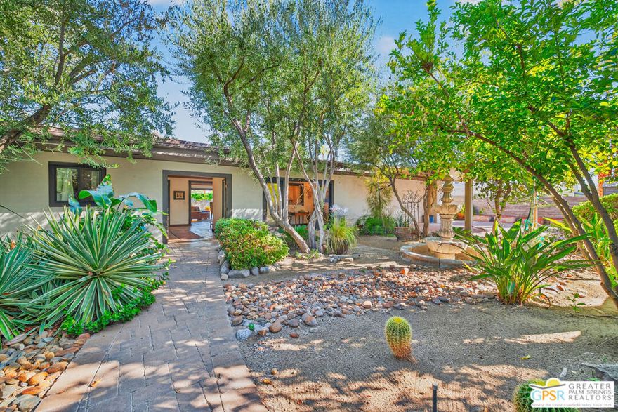 Spectacular Southwestern Mini Compound with a European flair located in a quiet corner of the esteemed Palm Springs neighborhood, Twin Palms. Wonderfully private and gated home with a stunning desert sanctuary garden that captivates you upon entrance to the home. The grand foyer greets you with all the charm and elegance of an Old World Estate that leads you into a large kitchen and living areas then pulls you to the beautiful pool deck. The kitchen has a large bar counter for 5, high end stainless appliances, tons of cabinet storage and a charming Breakfast Morning Room to enjoy your coffee or tea overlooking the beautiful front oasis. The Living Room has a grand fireplace, large built in cabinets for TV and collectibles and a whole wall of doors that open up to the pool and pool deck. If you enjoy entertaining and hosting parties, you will love the Dining Room that is fit for royalty and memorable evenings - once again with French Doors that open to the Pool just beyond. The huge Primary Bedroom sits away from the other Guest Rooms and includes a fireplace, French Doors to the pool deck and a primary bath that you can get lost in! A walk-in shower and soaking tub center the room with a dual sink vanity, private commode and a walk-in closet with plenty of room for clothing. Two other spacious guest bedrooms have en-suite bathrooms and are filled with charming details. Once you make it to the back patio, enjoy the large pool for those famous Palm Springs pool parties or simply swimming laps, all with stunning Western mountain views. There is a cute Casita off the pool that is perfect for a pool house, office, artist studio, Tiki Lounge or anything you can imagine surrounded by mature desert landscaping all with privacy and views. Private mini compound on Fee Simple land, sanctuary oasis garden, mature landscaping, Old World charm, spacious living areas, indoor-outdoor living perfect for the desert and located in one of Palm Springs' most prestigious neighborhoods. Don't miss out on this special home!