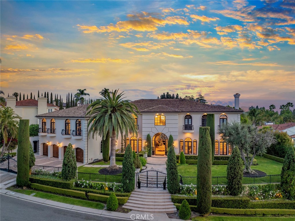 Welcome to your dream home in the prestigious Nellie Gail Ranch—a beautifully renovated executive estate tucked away on a serene cul-de-sac. This grand residence offers a perfect blend of luxury, comfort, and functionality, making it ideal for both sophisticated entertaining and everyday family living.
From the moment you step through the impressive double-door entry, you’re greeted by refined elegance and timeless design. A dramatic floating staircase anchors the foyer, flanked by formal living and dining rooms that exude classic charm. The inviting family room is bathed in natural light and showcases picturesque views of the lushly landscaped backyard, complete with a sparkling saltwater pool, tranquil waterfall, and vibrant greenery. The completely remodeled chef’s kitchen is a culinary masterpiece, featuring professional-grade appliances, exquisite cabinetry, and a cozy breakfast nook that flows seamlessly into the main living areas. Upstairs, the luxurious newly updated primary suite is a private retreat with a all new bespoke custom marble bathroom suite with his and her quarters, opening onto a spacious covered deck with serene backyard vistas. It boasts dual walk-in closets, a double-sided fireplace, a stylish sitting area, and sophisticated modern finishes throughout. The estate includes a richly paneled executive office, charming Juliet balconies, French doors throughout, and thoughtfully upgraded oversized 4 car garage space. This meticulously crafted home is filled with extraordinary details—and a fully equipped Chefs outdoor kitchen perfect for world class dining. Experience Resort living at its finest. This is more than a home its a statement of quality, comfort and lifestyle in one of Orange Countys most distinguished neighborhoods.
