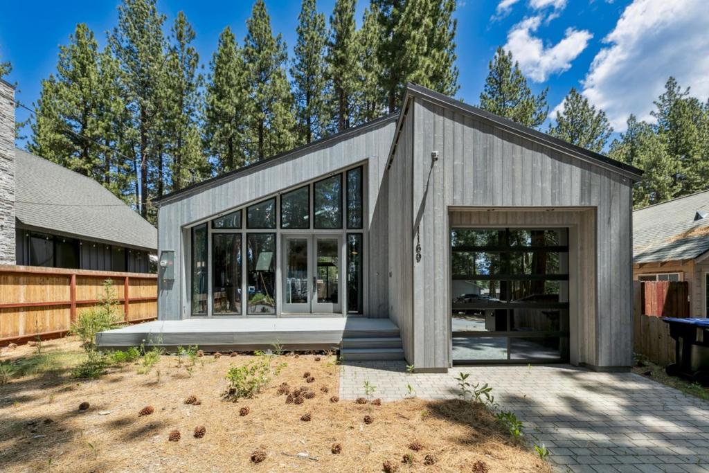 This stunning home, thoughtfully designed and custom built by SHEMSS in 2022, is a rare gem that blends modern elegance with a custom Scandinavian touch. Featuring soaring wood-vaulted ceilings, full window walls, and an open-concept layout, it is filled with natural light and captures breathtaking mountain views. The sleek, European-style kitchen with hidden appliances is a chefs dream, perfectly designed for both function and style. The serene primary suite offers a spa-like escape with a freestanding soaking tub, while the stunning living room opens directly to a spacious private deck and an expansive yard, ideal for entertaining or relaxing. Centrally located near Hwy 50, fine dining, shopping, scenic bike trails, and just a short distance from Heavenly. This home is the perfect fusion of modern design and relaxing mountain lifestyle. Don't miss it!