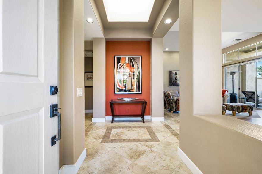 This beautiful & meticulously maintained Acacia-4 sits on an elevated lot with views of the Arnold Palmer Grove-4 course and majestic Chocolate mountains in the background. Upgrades include totally remodeled kitchen (2023) with new counter tops, gas cooktop, stainless appliances, chic backsplash, gooseneck faucet, new water heater (2023), & rear patio pavers.   The dining area houses a huge wall to wall custom buffet with two beverage coolers; one for wine and one for non alcoholic beverages. The original pony wall in the great room has been removed to create an expansive feel & a flat screen 65'' wall mounted TV sits above the fireplace. Each bedroom is ensuite and one of the guest bedrooms has a custom wall to wall desk plus two pull-out sofa beds for guests & family members to enjoy. The lovely primary ensuite boasts a frameless shower stall,  jetted tub, and looks out to a serene private patio for maximum relaxation. The 2 car garage plus golf cart space has an epoxy floor and mini split A/C. Located in the HOA where monthly dues include all gardening (front yard, courtyard & rear) exterior water, tree trimming, painting & electricity, roof maintenance, wi-fi, cable, trash, & pest control, all for lock & leave stress free convenience. One of the 38 community pools is just 4 doors away and Club membership is available with no wait.