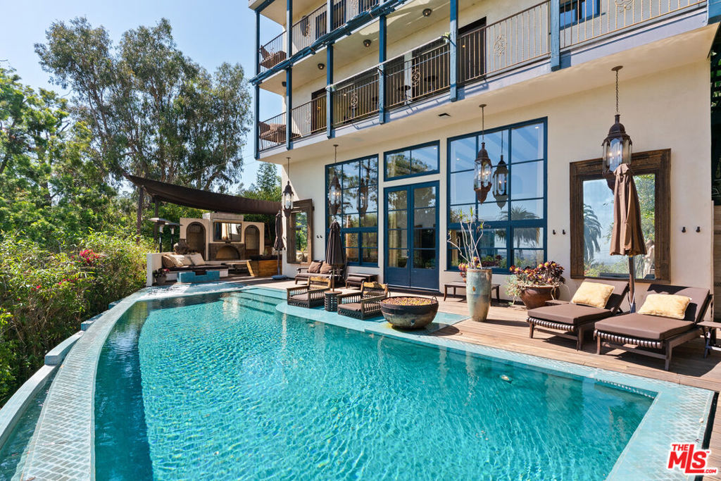 Nestled on coveted St. Ives Drive-just steps from Soho House and The Edition-this Spanish-Moroccan retreat is perfect for entertaining. A caisson-built infinity pool and spa frame sweeping treetops and West Hollywood vistas, while an expansive, greenery-draped deck ensures seclusion in Lower Doheny / Bird Streets. Parking for four cars (two-car garage plus driveway) makes hosting effortless, yet the quiet, flat street leads in moments by foot to Sunset Strip's premier dining and nightlife. Each of the home's three levels-including the expansive pool terrace-showcases stunning south-facing views. The Great Room, crowned by 20-ft ceilings, a full-height glass wall and integrated AV, opens to a sunny infinity pool, spa, outdoor kitchen, fireplaces, canopy-shaded lounges, outdoor showers and premium A/V. Retreat to the lower level spa with gym, hammam, whirlpool and hydro-massage suite finished to Aman standards. Restored with new flooring, custom cabinetry, bespoke fabrics and designer canopies, 9140 St. Ives Drive awaits its next discerning owner. All furnishings available.