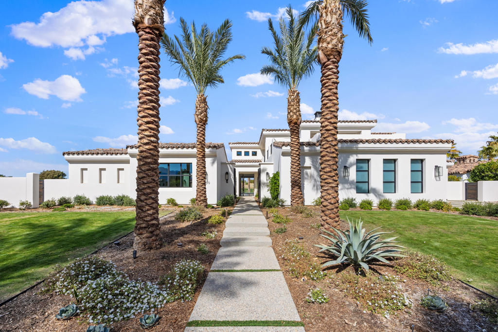 This exquisite custom-built home, positioned along the 8th fairway of the renowned Clive Clark Course, enjoys breathtaking, unobstructed views of two fairways, with no homes to interrupt the serene landscape. Spanning two levels and featuring a detached casita, this luxurious residence offers 4 spacious bedrooms, 4.5 beautifully designed bathrooms, a 4-car garage, and an impressive 4,370 sqft of sophisticated living space. The open-concept floor plan effortlessly connects the main living areas, featuring soaring ceilings and a striking floating staircase. Expansive glass walls create a seamless flow between indoor and outdoor spaces, allowing natural light to flood the home. The gourmet kitchen, outfitted with top-tier appliances and a convenient butler's pantry, is perfect for crafting culinary masterpieces. The primary suite is a peaceful retreat, showcasing stunning views of the golf course and desert landscape. A cozy fireplace enhances the relaxing atmosphere, while the spa-inspired bath, complete with luxurious stone finishes, a freestanding tub, and a steam shower, offers the ultimate in comfort. Upstairs, a guest suite with a spacious living area, bar, and wraparound terrace provides sweeping views of the Santa Rosa Mountains. The private casita offers a peaceful escape with its own secluded patio. The outdoor space is an entertainer's dream, featuring a sleek pool, soothing spa, BBQ island, and intimate seating areas ideal for enjoying desert evenings. Experience the pinnacle of luxury living at The Hideaway.