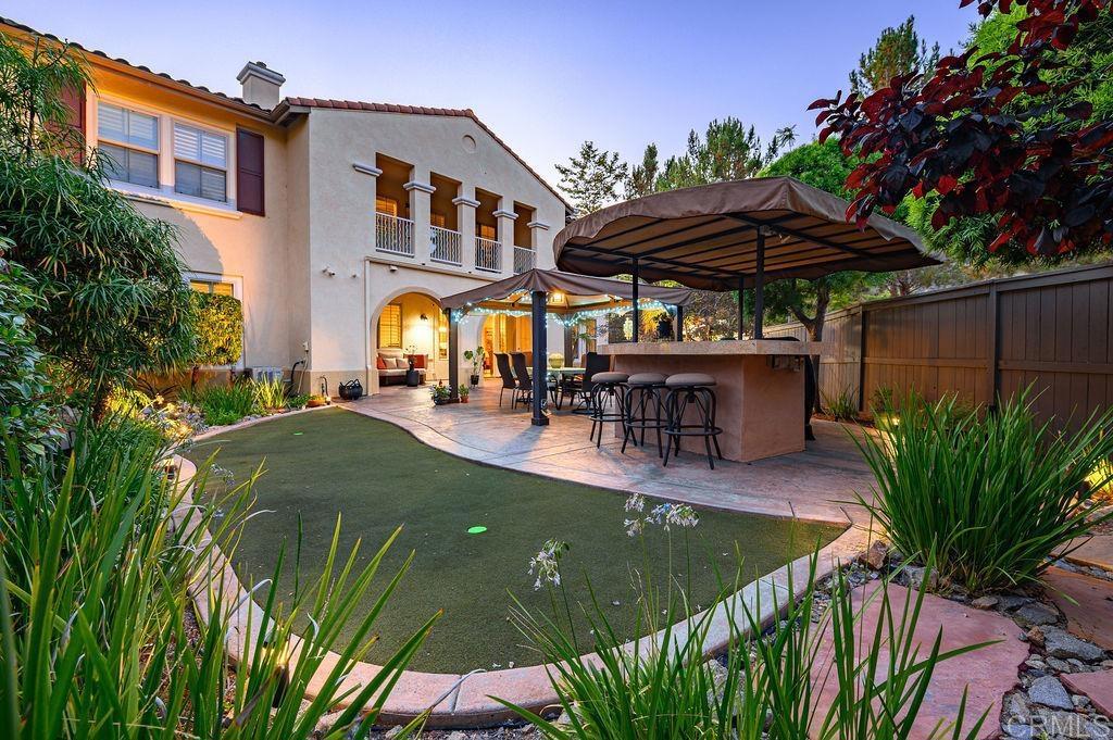 Truly One-of-a-Kind! This rare ground-floor, single-story end unit offers privacy, comfort, and a backyard oasis unlike anything else in the area. Enjoy recent upgrades including polished travertine floors, freshly painted interiors, refinished kitchen cabinetry, and fully remodeled bathrooms. Step outside and entertain with ease on your expansive private patio featuring a built-in BBQ station, custom putting green, and ample space for gatherings and relaxation. Tucked away from busy streets, this secluded end unit provides the perfect balance between peaceful retreat and entertainment hub. Homes like this are rarely available—and there’s only one like it. Don’t miss your chance to make it yours!