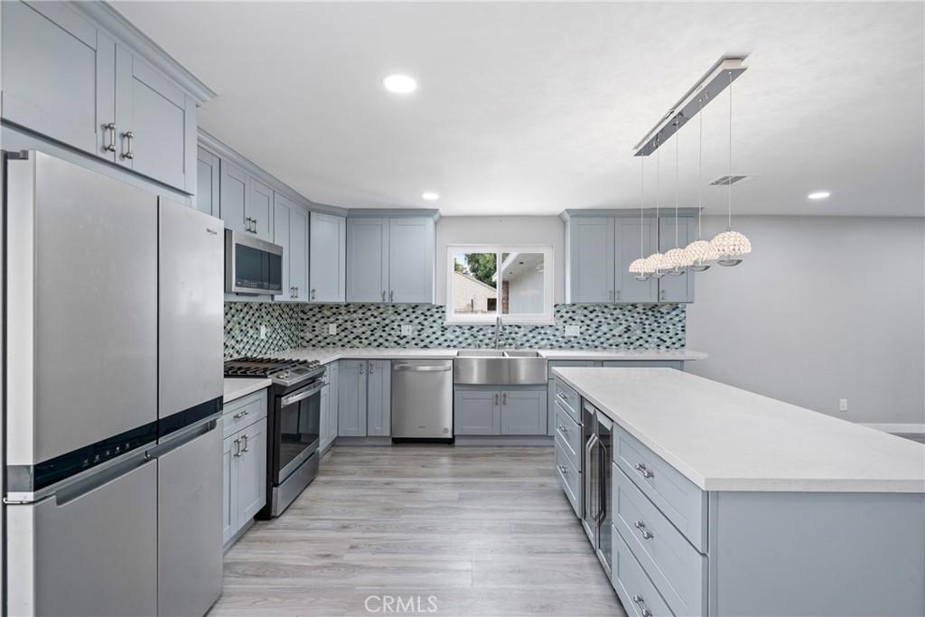 Welcome to this beautifully REMODELED 4-bedroom, 2-bathroom RANCH STYLE HOME! Ideal CUL-DE-SAC location in the sought-after BLANCO PARK community. The OPEN CONCEPT Living Space includes the LIVING ROOM, and stunning KITCHEN with LARGE ISLAND, QUARTZ COUNTERTOPS, STAINLESS STEEL FARMHOUSE SINK, WINE REFRIGERATOR, top-of-the-line ENERGY EFFICIENT STAINLESS STEEL APPLIANCES, and an abundance of SHAKER CABINETS. The PRIMARY SUITE is completed by a Fully RENOVATED BATHROOM featuring a DUAL SINK VANITY with QUARTZ CABINETS and SHAKER CABINETS, an OVERSIZED SEAMLESS GLASS SHOWER with a RAINFALL SHOWER HEAD, HANDHELD SPRAYER, BUILT-in BENCH, and ELEGANT MOSAIC TILE accents. Additional FEATURES and UPGRADES include: The HVAC system, TANKLESS WATER HEATER, ENERGY-EFFICIENT WINDOWS, Engineered HARDWOOD FLOORING, and PLUSH LUXURY CARPET. Expansive Backyard—meticulously designed with Beauty and “LOW” MAINTENANCE in Mind—with DROUGHT-TOLERANT PLANTS, brand new WOOD FENCING, and a spacious DECK complete with a PERGOLA SHADE Structure. OVERSIZED 2 CAR FINISHED GARAGE with EPOXY FLOORING, LAUNDRY ROOM with Utility Sink, and Approximately a 5-10 minute drive to award-winning schools, shopping centers, restaurants, and more. This home combines comfort, style, and convenience.