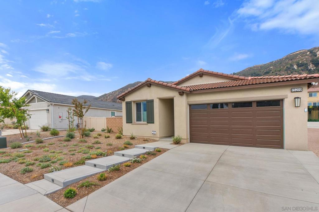 Welcome to this beautiful family home, less than a year old and in pristine, like-new condition! The Smart Choice: Skip the long build time, construction noise, and hidden costs—this home has already been upgraded and perfected for you. This beautiful residence boasts over $100,000 in premium upgrades, saving you significant time and expense. Exquisite, gleaming tile flooring flows throughout, complemented by an elegant kitchen backsplash. Enjoy pure, softened water with a top-tier water softener system. The expanded side yards with refined walkway, and property separation elevate curb appeal and functionality. The backyard is an entertainer’s paradise, featuring diamond-cut cement, low-maintenance turf, and a stucco-coated block matching wall/vinyl enclosing the yard for privacy and safety, all with a beautiful view of the mountain. Unwind on the upgraded patio with a 15 ft deep cover, complete with two cooling fans and six ambient lights. The garage dazzles with durable epoxy flooring, and an advanced 8-camera security system ensures peace of mind. Freshly painted interiors with upgraded sleek shutters on every window, and modern fans in every room create a turnkey home. With ample space for RV parking (HOA will approve, 12–16 ft wide to accommodate most RVs with ease) and room to add a pool, this expansive lot offers unmatched versatility. Nestled on one of the largest lots in the community—over 12,000 sq ft—Why wait and spend thousands on upgrades when this home has it all? Move in today and enjoy the cost savings of these professionally completed enhancements. Mello Roos may be assessed at some point, no info availble through the Riverside County Assessor as of listing date