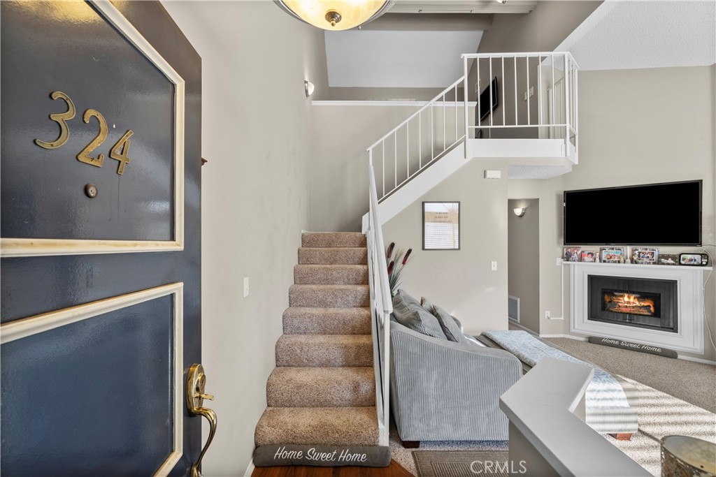 Bright & Spacious 2-Bedroom, 2-Bathroom Condo with Loft and Stunning Views! Welcome to this beautifully maintained corner unit in the heart of Canyon Country conveniently located to everything! Featuring 2 bedrooms, 2 bathrooms, a versatile loft, and a private 2-car tandem garage with additional storage, this home offers comfort, convenience, and captivating views. Step inside to soaring vaulted ceilings and an open-concept layout that creates a light, airy feel throughout. The inviting living room is anchored by a cozy fireplace and seamlessly connects to the dining area—ideal for everyday living and entertaining. The bright kitchen is a chef’s delight, featuring generous granite counter space and a charming bay window that fills the space with natural light and serene views of the lush community landscaping. Both bedrooms are generously sized and offer peaceful retreats, while the two full bathrooms are thoughtfully updated with both style and functionality in mind. Upstairs, the spacious loft provides flexible space perfect for a home office, guest area, or playroom. Enjoy your morning coffee or evening unwind on the private balcony, taking in the tranquil, scenic surroundings. Additional features include an indoor laundry area, a large two-car tandem garage with plenty of storage, and access to community amenities including swimming pools, tennis courts, and playgrounds. This home is just minutes from local parks, top-rated schools, shopping centers, restaurants, and major freeways—putting everything you need right at your fingertips. Don't miss the opportunity to own this light-filled, turn-key condo in a sought-after community. Welcome home!