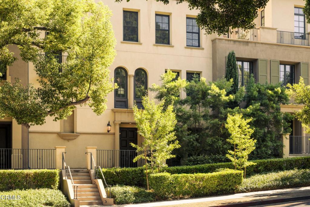 Welcome to the Villas at Ambassador Gardens, a prestigious community adjacent to Old Town Pasadena. The Contemporary Mediterranean style townhomes exude elegance, and are sited on meticulously landscaped grounds. This four story unit with a rooftop patio has been updated with designer taste to emulate class, style, and flair. Enter the unit and find the formal dining room with large windows and high ceilings. The formal living room has a new fireplace surround, mantel, and screen, high ceilings, recessed lighting, built-in bar, and folding glass doors to the patio. The kitchen has been beautifully updated to feature new countertops, a new backsplash, a new refrigerator and freezer, new range hood, and a new dishwasher. The second floor showcases the stunning primary suite with large windows, seating area, and spacious closet. The primary bathroom has dual sinks, shower and bathtub, and separate vanity area. The second bedroom and ensuite bathroom is also on the second floor. The third floor offers a large family room/entertainment space with new wood floors. There are also two more bedrooms with ensuite bathrooms and a large laundry room with storage. The top floor has a bar area, and leads to a roof top outdoor patio with a fireplace and stunning views of the San Gabriel Mountains. The newly epoxied 835 square foot garage offers plenty of space for up to 4 cars, or could make a great gym space. There is also an adjacent storage space accessed through the garage. An elevator going to each floor provides convenience and ease. A 2025, technologically innovative, San Marino Security system was recently installed. Come enjoy this truly stunning townhome.