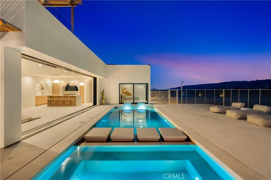 ATTENTION INVESTORS - High Income property ,Stunning Ibiza-Style Desert Oasis: A Once-in-a-Lifetime Opportunity

Welcome to your dream home – a unique 1,540 sq. ft. Ibiza-style residence nestled in the breathtaking desert landscape. This fully custom property offers an unparalleled living experience, perfectly designed for both relaxation and entertainment. Upon entering this exquisite home, you will be greeted by an impressive 30-foot pocket door that seamlessly merges indoor and outdoor living, allowing you to fully appreciate the natural beauty of the surrounding 2.18 acres, complete with stunning views of the Joshua Tree Monument. The design promotes an effortless flow throughout the space, making it ideal for gatherings or tranquil evenings. Step outside to discover over 700 sq. ft. of rooftop space, featuring a stylish pergola that provides 360-degree views of the desert landscape—an ideal backdrop for sunset cocktails or stargazing. The expansive outdoor deck boasts a sunken seating area capable of accommodating over 20 guests, making it an entertainer's paradise. This home is meticulously crafted with imported custom furniture and finishes, showcasing the finest materials. Each corner of this residence radiates charm and sophistication. Culinary enthusiasts will appreciate the full BBQ kitchen, perfect for summer cookouts, while the sunken fire pit and additional rooftop fire pit create an inviting ambiance for evening gatherings under the stars. Adding to the allure of this property is a large pool complemented by an oversized jacuzzi, providing a luxurious retreat perfect for both the hot desert days and chilly nights. Secluded yet accessible, this property represents a fantastic investment opportunity or an idyllic vacation home. Equipped with a well system, solar power, and an EV charger, this residence combines sustainability with luxury living. Don’t miss your chance to own this extraordinary desert retreat—a true gem that encapsulates the essence of modern living in harmony with nature. Schedule your private tour today!