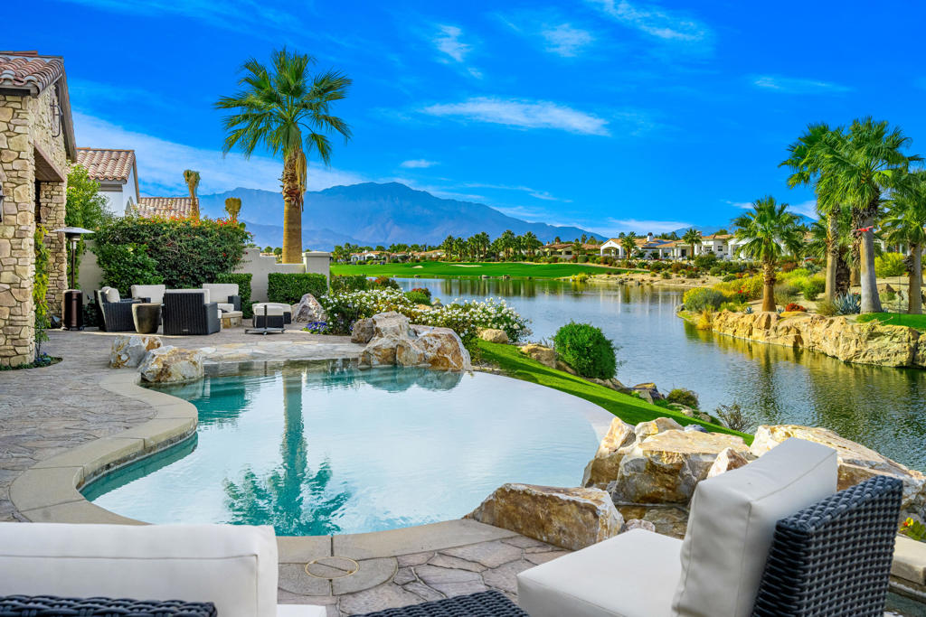 STUNNING RESIDENCE WITH UNMATCHED VIEWS! Discover your private oasis nestled in the heart of Indian Wells within the prestigious Toscana Country Club. This prime 4,930 SF home is perfectly positioned on an expansive homesite offering sweeping views of lakes, mountains, golf course and unforgettable desert sunsets. Home features 4 spacious en-suite Bedrooms which includes a private Casita with separate sitting room as well as a separate powder room. Perfect for the entertainer, the home's gourmet Kitchen features a generous center island, large pantry, top-tier appliances for any culinary endeavor, breakfast bar and nook with direct access to courtyard lounging area by a fireplace. Also included is an exquisite formal Dining Room with walk-in temperature controlled Wine Room that can be accessed from both Dining Room and Kitchen. Enjoy seamless indoor and outdoor living with multi-slide 10' pocket doors. Exceptional outdoor haven includes BBQ center, firepit with seating area, raised custom spa, stone waterway and infinity pool which appears to flow into the lake. Simply serene. Offered furnished per inventory.