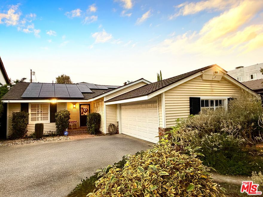 A rare opportunity to own a large-lot single-level home in the heart of Chandler Estates, one of Sherman Oaks's most sought after neighborhoods. Owned by the same family since the home was built in 1955, this residence has been thoughtfully maintained and upgraded from top to bottom, blending timeless charm with modern sophistication. Set on a wide, tree-lined street, the home draws you in with custom exterior lighting, a brick walkway, and refreshed front landscaping, featuring a tranquil dry riverbed and fountain. The home's carefully curated garden spaces, designed for low maintenance and maximum enjoyment, include a gazebo with integrated lighting, perfect for an al fresco meal or stargazing. Mature trees and open spaces offer both shade and sunshine, privacy and connection. Inside, the home exudes comfort and quality. Hardwood floors lead you through the house's light-filled rooms, all framed by plantation shutters. Two sets of French doors open to the backyard, effortlessly facilitating the indoor-outdoor lifestyle California is beloved for. The fully remodeled kitchen is the heart of the home. Both beautiful and functional, the modern cabinetry, premium fixtures, and spacious pantry make cooking and entertaining a delight. This home features three stylish bathrooms - two full and one powder room - each with elegant tile work, glass enclosed showers, custom vanities, and spa quality lighting. The den can easily be converted into a 4th bedroom. Major system upgrades include a new electrical panel, central air and heat, copper plumbing with replaced valves, and a tankless water heater. The home also features a newer roof, modern garage door, and a comprehensive alarm system for peace of mind. Solar panels enhance sustainability and reduce utility costs. Located in the prestigious Chandler Estates, this home sits moments from Ventura Boulevard's boutiques and cafes, with easy access to major freeways and top-rated schools. The neighborhood's wide lots, character homes, and quiet streets make it one of Sherman Oaks's most desirable addresses. Lovingly maintained and updated by one family for nearly seventy years, this home strikes the perfect balance between vintage charm and contemporary comfort. This home is a true Chandler Estates gem, ready for its next chapter.