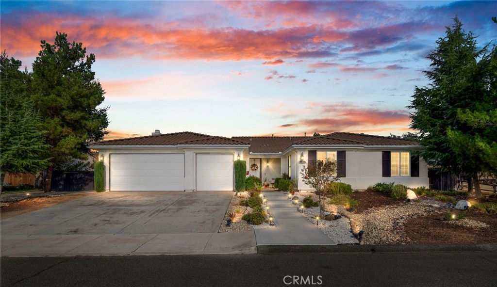Welcome home to this beautifully maintained single-story retreat tucked at the end of a quiet cul-de-sac, where neighbors still wave hello and life feels a little slower without sacrificing convenience. Set on nearly half an acre of flat, fully usable land, this 4 bedroom (plus an office), 3 bath home offers over 3,100 square feet of living space designed for gathering and everyday comfort. Inside, you’ll find soaring ceilings, rich millwork framing every window and doorway, and timeless Quartzite flooring flowing through the main living areas. The remodeled kitchen is the heart of the home, with an oversized island, sunny breakfast nook, crisp white cabinetry, quartz countertops, and stainless steel appliances opening seamlessly to the family room with fireplace. The spacious primary suite features a coffered ceiling, backyard access, dual vanities, soaking tub, and walk-in closet, while the secondary bedrooms are generously sized, including a guest wing with remodeled bath and walk-in shower. Thoughtful details continue throughout, from built-in cabinetry in the garage to upgraded baseboards, wood flooring, and custom carpets. Step outside and discover an entertainer’s dream yard, complete with an expansive covered patio, BBQ island with sink and fridge, and multiple seating areas shaded by mature trees, including ten fruit trees and more than thirty others planted for beauty and privacy. Enjoy lemon, lime, orange, pomegranate, grapefruit, and fig, plus fragrant rosemary bushes. The manicured grounds are ready to enjoy today, yet the flat lot also offers incredible potential for the future. Plenty of space for both an ADU and a pool, with room to spare. A large shed with electricity adds storage or hobby space, and utilities are in place for a spa or fire pit. Here, you’re minutes from shopping and conveniences, yet the peaceful setting feels worlds away. With leased solar for energy savings, a three-car garage, and a welcoming neighborhood that truly feels like home, this property is the perfect blend of comfort, charm, and opportunity.