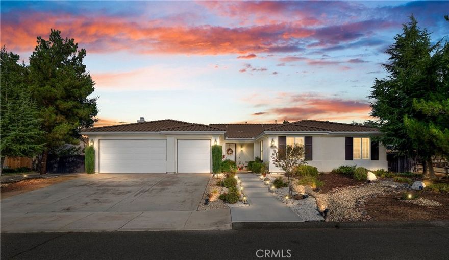 Welcome home to this beautifully maintained single-story retreat tucked at the end of a quiet cul-de-sac, where neighbors still wave hello and life feels a little slower without sacrificing convenience. Set on nearly half an acre of flat, fully usable land, this 4 bedroom (plus an office), 3 bath home offers over 3,100 square feet of living space designed for gathering and everyday comfort. Inside, you’ll find soaring ceilings, rich millwork framing every window and doorway, and timeless Quartzite flooring flowing through the main living areas. The remodeled kitchen is the heart of the home, with an oversized island, sunny breakfast nook, crisp white cabinetry, quartz countertops, and stainless steel appliances opening seamlessly to the family room with fireplace. The spacious primary suite features a coffered ceiling, backyard access, dual vanities, soaking tub, and walk-in closet, while the secondary bedrooms are generously sized, including a guest wing with remodeled bath and walk-in shower. Thoughtful details continue throughout, from built-in cabinetry in the garage to upgraded baseboards, wood flooring, and custom carpets. Step outside and discover an entertainer’s dream yard, complete with an expansive covered patio, BBQ island with sink and fridge, and multiple seating areas shaded by mature trees, including ten fruit trees and more than thirty others planted for beauty and privacy. Enjoy lemon, lime, orange, pomegranate, grapefruit, and fig, plus fragrant rosemary bushes. The manicured grounds are ready to enjoy today, yet the flat lot also offers incredible potential for the future. Plenty of space for both an ADU and a pool, with room to spare. A large shed with electricity adds storage or hobby space, and utilities are in place for a spa or fire pit. Here, you’re minutes from shopping and conveniences, yet the peaceful setting feels worlds away. With leased solar for energy savings, a three-car garage, and a welcoming neighborhood that truly feels like home, this property is the perfect blend of comfort, charm, and opportunity.