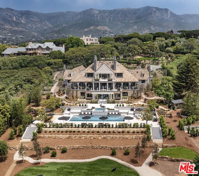 Welcome to 256 Las Entradas Drive, a stunning and completely re-imagined Montecito Estate that captures the beauty, exclusivity, and serenity of everyone's dream haven. Located in one of Montecito's most sought-after communities Ennisbrook - this ultimate private sanctuary has vast ocean views as soon as you enter through the towering gates and into the oversized motor court. Continue enjoying the ocean views as you walk through every level of this prestigious home. Pass by the rounded, architectural staircase as you enter the foyer. Follow the white oak wood and white Semco flooring throughout, complemented by all new lighting fixtures from Ochre, Mattaliano, Apparatus, and Ann Sachs. Cozy around the fireplaces in the relaxing living areas and dining area on the main floor and utilize all the high-end features of the impeccable chef's kitchen while watching the sun set over the ocean. Kitchen features include multiple stunning True refrigerators and freezers, Wolf range and warming drawers, a Paradigm Alkaline soft water system as well as a Butler's Pantry.The upper level serves as the sole primary suite, featuring a grand fireplace, ocean-view terrace, and dual his-and-her bathrooms and closets. "Her" bathroom offers Italian marble flooring and shower, stand-alone tub, 360-degree vanity, salon-style shampoo area, fireplace, and showroom-like closet. "His" bathroom features a Japanese soaking tub inside the Italian marble walk-in shower, a TV lounge, and rows of built-in closets and drawers. The lower level features a Laughlin A/V theater, a fitness center with its own kitchenette and an entertainment lounge with sliding glass doors that leads to the impressively landscaped grounds. Designed for resort style living, here you will find a newly built expansive swimming pool and spa, multiple lounging and dining areas, and a multi-purpose open-air greenhouse where you can dine under the stars.Overall, this modern estate has been thoughtfully designed to cater to your relaxation, entertainment, fitness, and social needs, creating an all-encompassing space that brings luxury and comfort together.