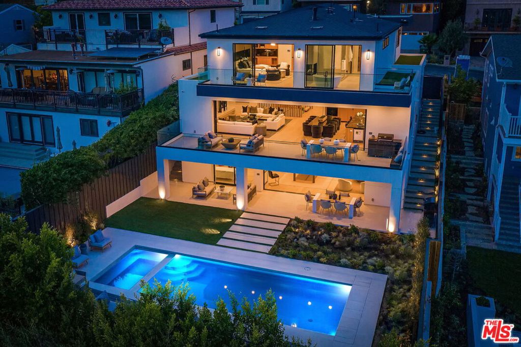 Exquisite New Modern masterpiece perfectly situated steps from the new Pacific Palisades Village with sprawling queens necklace Ocean views. Immediately be drawn in by sleek elegant finishes throughout this 3 level warm architectural with elevator and floating staircases. This incredible home boasts a main level with living room with porcelain fireplace,family room and library/office ,beautiful open kitchen and oversized decks perfect for indoor or outdoor dining with overhead heaters and automatic fleetwood pocket doors,BBQ and the most amazing ocean views. Four bedrooms on top with ensuite bathrooms and custom closets ,laurndry room,elegant master suite with its own massive deck with yet more mesmerizing ocean views. The lower level has another bedroom with ensuite bath,additional laundry,a lush theatre with permanent seats and led cove lighting,Gym area with steam shower and dry sauna,spacious entertainment area with bar which opens to a spacious backyard with another BBQ and an oversized sparkly salt water pool. 5 parking spaces,complete control four system,dramatic wood accents,porcelain and quartz stone,mirror accents,european lighting,the list goes on and on. A coastal modern newly constructed gem Not to be missed.
