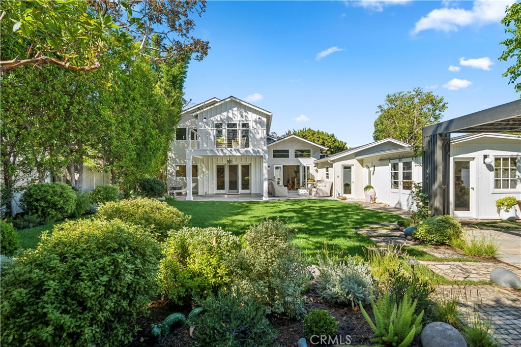 This is the ultimate retreat! From the moment you step through the gate, a wave of tranquility washes over you. It’s a serene oasis that's truly beyond words. Let me paint a picture of this exceptional property for you. Spanning just over 11,250 square feet, the lot offers access from both Del Mar Ave and Fairway Drive. The entire space is expertly designed with beautiful hardscaping and landscaping that pays meticulous attention to every detail. Imagine outdoor dining areas, cozy conversation spots, gentle fountains, raised garden beds, and mature trees thoughtfully positioned across the expansive grounds.
The residence has been completely renovated, stripped down to the studs, expanded to 2,624 square feet, and expertly rebuilt by the current owners as their ideal residence. The timeless layout and design of the home promotes both a sense of openness and inviting privacy. At the heart of the home is the kitchen, featuring dramatic vaulted ceilings, top-of-the-line built-in appliances, and a stunning single slab Calcutta kitchen island.
There are three additional living areas: a living room with vaulted ceilings and custom built-ins, a family room that looks out onto the outdoor patio and sprawling backyard, and a dining area that opens up with double French doors. Each of the three secondary bedrooms is filled with natural light, one of which is a suite complete with an ensuite bathroom and walk-in closet. The other two bedrooms share a private bath, and there’s a convenient powder room for guests.
Upstairs, you’ll find the primary suite, complete with a luxurious ensuite bathroom that features a walk-in closet, a spacious soaking tub, dual vanities, and a separate shower. There's a small office that can be closed off from the primary bedroom and offers additional closet space. Step outside onto the fantastic deck that overlooks the park-like backyard.
Additional structures not included in the home’s size comprise a garage, a mud room/laundry room, and a 350 +/- square foot studio space. Recent improvements made in 2025 include a new central air conditioning, a newly poured concrete driveway and gate, a refresh of the landscaping and hardscaping, and a full property fumigation in 2023.
This remarkable eastside property stands peerless. While the pictures are breathtaking, they can’t fully convey the emotion and experience of visiting this home in person.