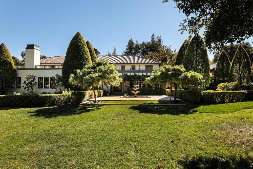 Majestic Mediterranean and equestrian estate on secluded 8.7 acres in central Woodside. 4 bedroom/4.5 bath in main 6300 sq ft + residence includes expansive great room overlooking grounds with with additional study/5th bedroom option. Primary bedroom includes luxurious bath, two large walk in closets, and private rooftop deck with view of the grounds and western hills. Charming courtyard takes you to 3 studio guest apartments, detached office, gym and pathway to additional office/guest house. Breathtaking grounds feature stone terrace off the great room with outdoor fireplace, pool, spa, tennis court, historic 10 stall barn, paddock and riding arena all surrounded by natural grasses, expansive lawn, apple orchard, and stunning oak and redwood trees. This creekside setting allows for the ultimate in privacy and serenity just minutes to Town, Woodside Schools, and all the amenities of Silicon Valley living.