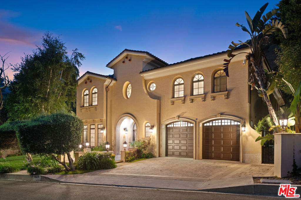 Tuscan-inspired architecture defines this exceptional 2007-built private estate perched on top of a quiet cul-de-sac in premier upper Brentwood neighborhood North of Sunset. Over 6,200 sq. ft. of living space on over 11,000 sq ft lot with pool & spa make this 6-bedroom, 6.5-bath residence the epitome of California luxury living. The 2 story floorplan features a layout designed with functionality, comfort, & modern living needs. Welcome guests into a grand entry with soaring ceilings, marble floors, tall curved staircase, formal living room with ornate fireplace, bright dining room, wine cellar, family room with fireplace, & 2 spacious ground floor bedrooms. The chef's center island kitchen boasts Sub-Zero double door refrigerator, Miele appliances, butler's pantry, & breakfast nook opening to the family room with French doors & direct access to the pool & patio. The upper landing of the grand foyer leads to separate wings featuring four en-suite bedrooms plus a versatile media/game /study room. The primary suite is a deluxe retreat with a sitting room, fireplace, balcony, spa bath with steam shower, dual water closets, & a stunning custom oversized walk-in closet. Highlights include 4-car garage, outdoor BBQ & fire pit, laundry room, coffered ceilings, custom crown moldings, elegant wrought-iron railings, multiple balconies, arched doors with decorative glass panels, circular inlaid stone medallion in the stone tile polished floor. Timeless in style & sophistication, this beautiful property feels private, warm, the spaces filled with light, openness, and quality craftsmanship.