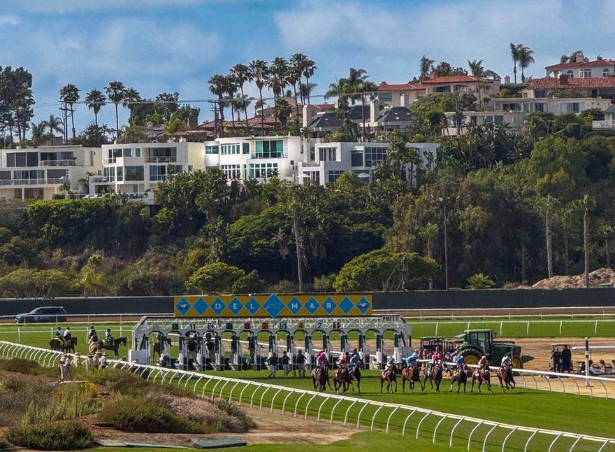 Watch the waves. See the finish line.  Set above the sand and the track, this gated Del Mar residence offers nearly 4,000 square feet of living space, panoramic whitewater ocean views, and a unique vantage point of the Del Mar horse races.  Fully remodeled with modern coastal vibes, the home works perfectly as a full-time residence or a lock-and-leave retreat.  The main level’s great room combines expansive ceilings, oversized viewing windows, and a bar just off the living area—ideal for entertaining. Glass panels open to an ocean-facing patio with uninterrupted views of the Pacific, the Del Mar Beach Colony, and the Del Mar Race Track.  Four bedrooms are arranged for privacy, including a top-floor primary retreat with sweeping vistas and a freestanding soaking tub. Additional features include a 600-bottle wine wall, Labradorite countertops that shift color with the light, a spa, and a two-car garage.  On race days, the energy of the finish line carries across the track. Step outside and you’re next door to The Brigantine, minutes from Del Mar Dog Beach, and directly across from the shops and galleries of Cedros Avenue.  Offered for purchase and for lease, fully furnished and turnkey. Rates: $25K/month (Sept–May), $35K/month (June–Aug).