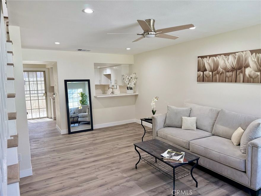 Back on market! Buyer could not perform! Welcome to this beautifully remodeled townhouse-style condo, nestled within a secure gated community in the heart of Compton. This spacious two-bedroom, one-and-a-half-bath home features a thoughtful layout, with both bedrooms and the full bathroom located upstairs, and a convenient half bath on the entry level. Step inside to luxury wood-style vinyl flooring and recessed lighting throughout. The fully renovated kitchen boasts brand-new shaker cabinets, quartz countertops, and stainless steel appliances — including a refrigerator, stove, microwave, and dishwasher. Just off the kitchen and dining area, enjoy a private patio with a storage room, perfect for relaxing or entertaining. Upstairs, you'll find the laundry room for added convenience. This home also features a brand-new HVAC system providing central air and heat — ideal for year-round comfort. The community is beautifully maintained, with lush landscaping visible right from your front door and windows. Don’t miss your chance to fall in love with this move-in-ready gem!