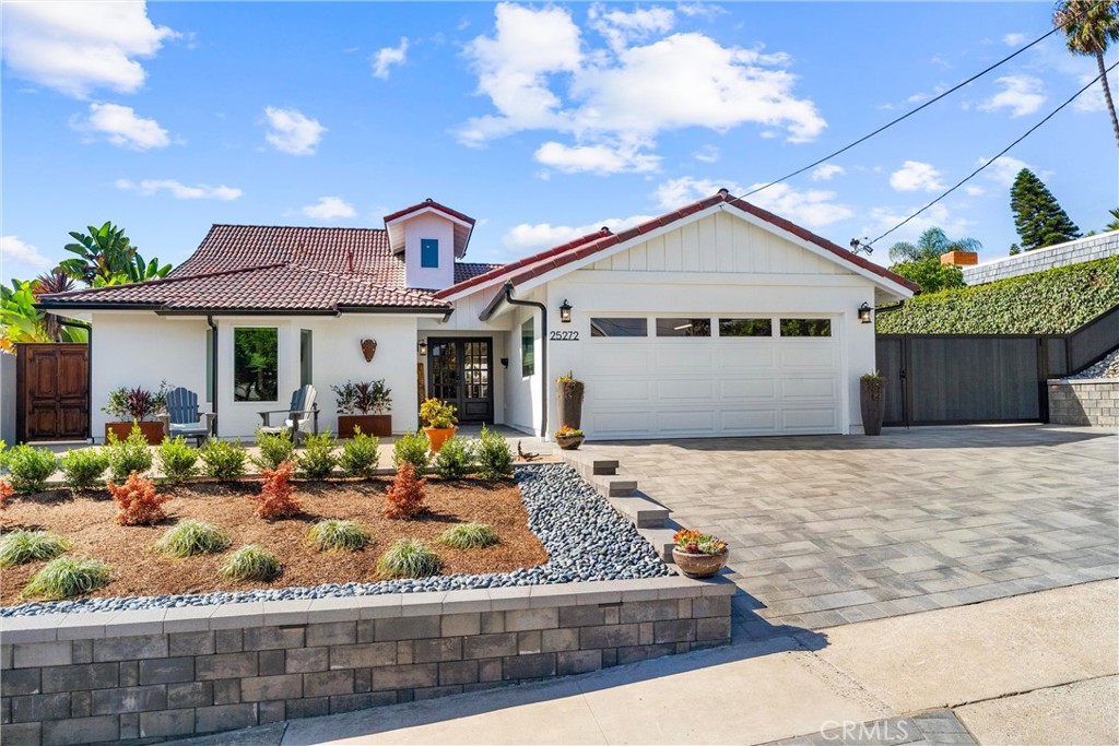 Located in the sought-after Dana Knolls neighborhood, this beautifully reimagined home blends coastal charm with modern comfort in a way that feels both timeless and fresh. Renovated from top to bottom with uncompromising attention to detail, the 2,156 square foot residence showcases smart design, impeccable craftsmanship, and extensive upgrades that make it as functional as it is beautiful.
At its center is the open-concept kitchen and expansive great room—a space designed for connection and comfort. Flooded with natural light from oversized windows and doors, it is anchored by a striking 50-inch linear gas fireplace, the perfect centerpiece for entertaining or quiet evenings at home.
The floorplan offers exceptional versatility. On the main level, a serene primary suite is complemented by two additional bedrooms, ideal for family or guests. Upstairs, a second primary suite opens to a newly re-built balcony with panoramic views and a peek-a-boo ocean glimpse. A flexible bonus room completes the layout, easily adapting as an office, playroom, or guest retreat. With four bedrooms, three beautifully remodeled bathrooms, and the bonus room, the home accommodates everything from family living to multi-generational needs.
The home's renovations rival new construction, extending far beyond cosmetic updates. Some highlights include a fully remodeled kitchen with top-tier appliances, three spa-inspired bathrooms, all new plumbing and fixtures, a 200-amp electrical panel, new HVAC, re-worked sewer lines, all new insulation, all new windows, smooth wall texturing, and interior solid-core doors. Wide-plank European wood floors and a custom indoor laundry add both style and function. What sets this home apart is not only the quality of its materials, but the care and thought in its design.
Outdoors, low-maintenance landscaping pairs with inviting entertaining areas, an oversized driveway, and a rare 74-by-14-foot gated side yard that easily accommodates an RV, boat, or other recreational toys. With Dana Point Harbor’s launch ramp just 1.5 miles away, adventure is always close — and storage costs disappear.
Efficient and easy to maintain, the home averages less than $200 per month in utilities and has no HOA, no Mello Roos, and no need for a gardener, delivering true simplicity and peace of mind.
25272 Yacht Drive is a rare opportunity to own an exceptional, turnkey coastal home—ready to enjoy today and for years to come.
