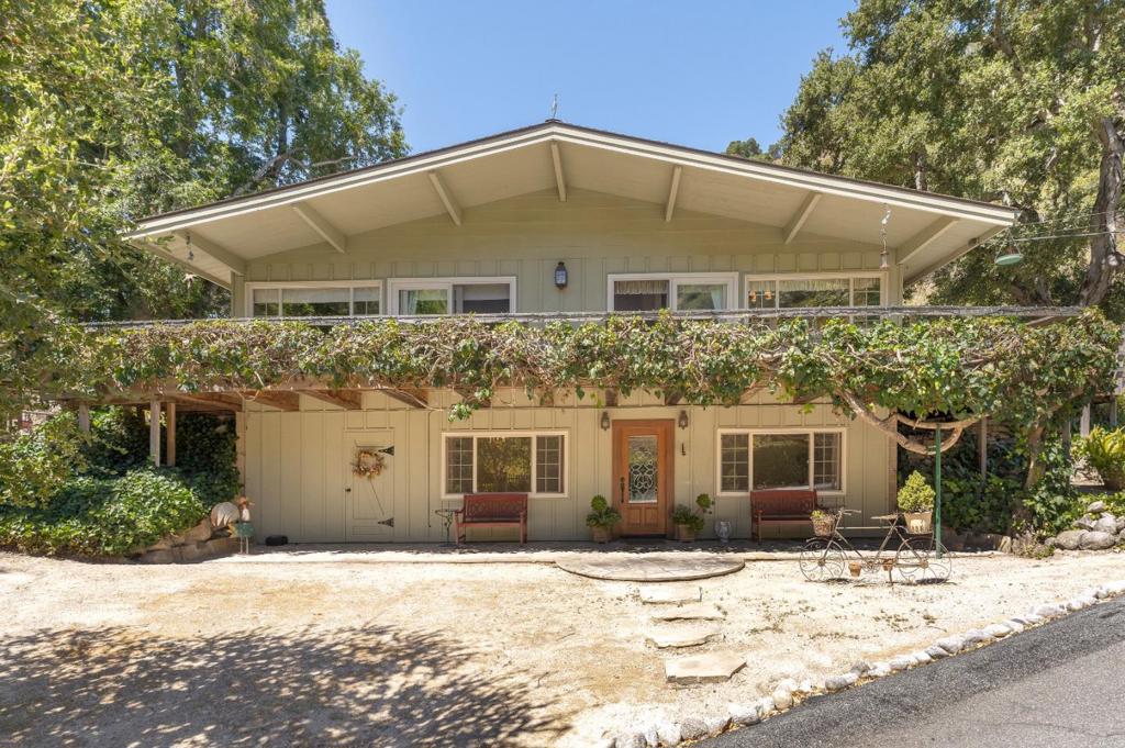 Secluded Sanctuary in Carmel Valley Have you been dreaming of finding an affordable property in Carmel Valley? Follow the private, gated driveway to a tucked away oasis, with stone pathways and mature landscaping. Designed by an animal lover with a spacious corral, covered building for horses/workshop and a delightful chicken coop. An expansive deck, ideal for entertaining, welcomes you onto the main living area. 1700 + sq. ft. 4 bedrooms, 2 baths on two levels with a flexible floor plan. The main level includes a country kitchen, living room, two bedrooms and a bath. The lower level with interior and exterior entrances, includes two bedrooms, a bathroom, laundry, and two bonus-flex rooms ideal for an office, playroom, income rental, gym or kitchenette. Bedrooms are spacious, with big windows and large closets. This cherished property can be enjoyed as it is now or it has the potential to become exactly what you have always wanted. Newer roof, windows and sliding doors.