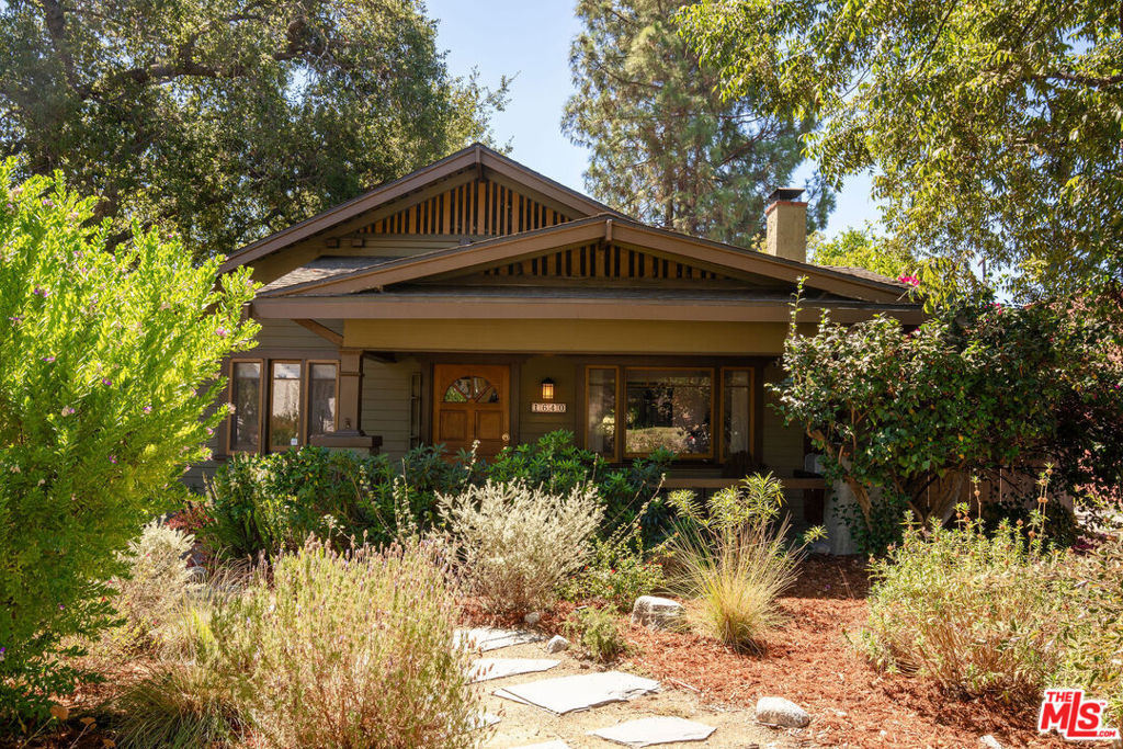 Classic elegance and serene charm define this beautifully restored Craftsman home, lovingly cared for over the years and nestled in one of Pasadena's most sought-after neighborhoods. Surrounded by historic trees and framed by stunning mountain views, it offers a tranquil sanctuary where life moves at a gentler pace. A wide front porch welcomes you, framed by native blooms and pollinator-friendly landscaping. Inside, original woodwork, a beautifully restored brick fireplace, open living and dining areas, and a vintage clawfoot tub create warmth and character, while sunlight pours through every window. Out back, a rustic retreat awaits with a an expansive deck, garden, and BBQ area, perfect for gathering with loved ones or simply unwinding. A long driveway with ample parking leads to a lofty one-car garage. Just steps from the tree-lined streets of Bungalow Heaven and local coffee and brunch spots. Featured in Pasadena Magazine this Craftsman blends classic architecture, thoughtful updates, and a vibrant location into a home that feels both timeless and full of life.