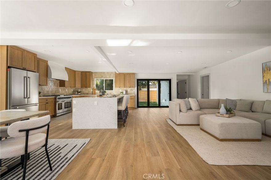Welcome to 3635 Conquista. This home has been remodeled with permits. As you enter the house, you will be in awe of the breathtaking kitchen that opens up to the living room and dining area. From the large waterfall island, soft closing drawers/cabinets, gorgeous custom tile, drawer microwave, custom hood, and a chef's dream come true range. The folding doors that stack to one side create the perfect indoor outdoor living. Enjoy your fireplace in your living room while looking out at your fire pit in your yard. With the expanded square footage, you now have a primary retreat that includes your bedroom, a beautiful bathroom, and a showstopper walk-in closet. With three more bedrooms, the hall bathroom has a bathtub, a shower combo, and a freestanding shower. Laundry hookups in the home, new A/C, new windows, doors, luxury vinyl flooring, landscaping, sprinkler system, and a finished garage. It’s true that the list of this remodel is long, but it won’t take long for you to fall in love with 3635 Conquista.