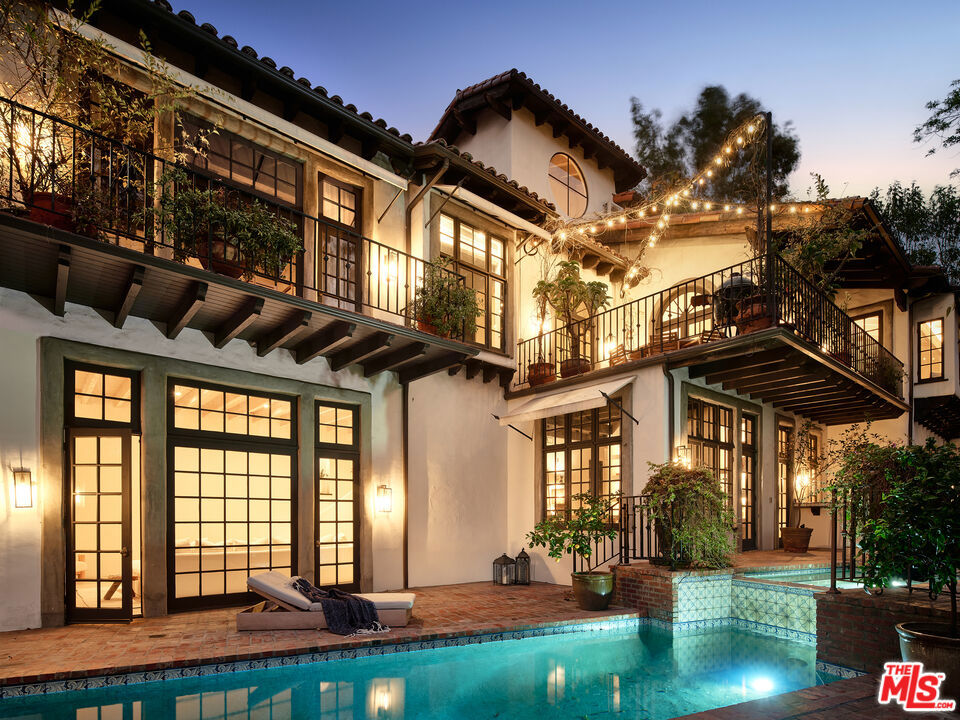 A Fred Smathers original, this Spanish masterpiece has been reimagined with exquisite attention to detail, blending timeless architecture with modern luxury. Nestled in highly desirable Nichols Canyon, just moments from Runyon Canyon and the heart of Los Angeles, the home offers both seclusion and convenience in one of the city's most coveted settings.Step into a dramatic entry with soaring ceilings, custom lime-plaster walls, and a sweeping grand staircase that immediately sets the tone. Designed for effortless indoor-outdoor living, the home features a gourmet kitchen, reimagined formal dining room, and expansive terraces ideal for entertaining. The living room is anchored by a fireplace and theater system, with French doors that open to a Spanish-style pool, spa, outdoor kitchen, and lush landscaping.The primary suite is a true retreat with vaulted ceilings, a fireplace, spa-inspired bath, private balcony, and intimate courtyard shower. Three additional bedroom suites, a tower office, and a custom wine cellar provide both versatility and sophistication. Every finish has been thoughtfully curated, from Spanish oak floors and artisanal plasterwork to radiant floor heating, integrated sound and lighting, smart home systems, and upgraded security.Outdoors, the saltwater pool and hot tub capture sunset views, while the property offers a two-car garage plus additional parking in the driveway. Located near "celebrity row" in the Hollywood Hills, this estate delivers a rare balance of privacy, luxury, and proximity to the best of Los Angeles.