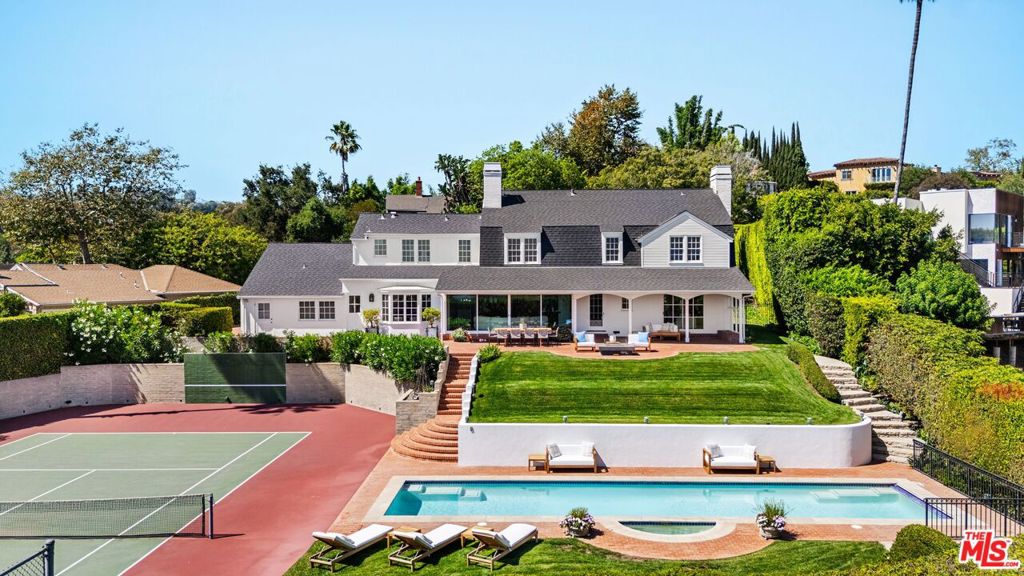 Tennis court estate on over half an acre designed in 1939 by renowned architect John Byers. This Dutch Colonial blends classic charm with modern luxury. Light-filled rooms, framed by Byers' signature windows, open to sweeping panoramic views of Los Angeles. Set on a private cul-de-sac above Sunset, the property offers resort-style living with a 50' lap pool, fire pit, fruit trees, and a championship-quality north-south tennis court. A guest cottage with full bath, designed by Nicholas/Budd Architects and built in 2014, complements the main home. With its secluded setting, landscaped yards, and advanced security system, this estate combines history, beauty, and privacy. Just moments from Sunset Blvd, the 405, and UCLA.
