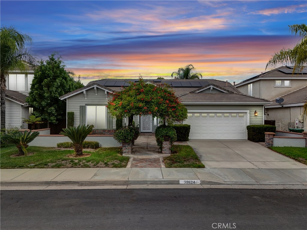 Nestled in the highly desirable Vintage Reserve community of Murrieta, this beautifully updated single-story home offers 3 bedrooms, 2 bathrooms, and approx. 2,025 sq ft of living space on a well-appointed 6,098 sq ft lot. From the moment you arrive, its curb appeal shines with a lush garden arbor entry, charming courtyard, and custom walkways. Inside, a formal entry welcomes you with abundant natural light and graceful arched doorways throughout. The spacious family room is anchored by a tile fireplace with a built-in TV cabinet and flows seamlessly into the dining area, where sliding glass doors open to serene backyard views. The gourmet kitchen is a centerpiece, featuring a custom hood vent, expansive cabinetry with decorative open shelving, beveled granite countertops, a large island with breakfast bar, and upgraded stainless steel appliances including a French door refrigerator, double ovens, and dishwasher. The master suite is a private retreat, complete with sliding door access to a side patio, a walk-in closet, and a spa-inspired bath with dual sinks, a designer-tiled walk-in shower, and a soaking tub framed in stylish tile accents. Two additional bedrooms are generously sized, and the hall bath offers double sinks and a shower-in-tub. The laundry room includes cabinetry and a utility sink with pull-out faucet for convenience. Interior upgrades include fresh paint, ceramic tile flooring with new carpet in bedrooms, plantation shutters and blinds, recessed lighting, upgraded ceiling fans, new black matte bath fixtures, and a new AC unit. Best of all, the home comes with fully paid-for solar panels and a Tesla wall mount, providing long-term energy savings and efficiency. Outdoors, the backyard is an entertainer’s dream, highlighted by an expansive wood lattice patio cover, custom stamped concrete, tranquil waterfall feature, manicured lawn, stucco-and-brick planters with lighting, and mature trees and shrubs. Located in one of Murrieta’s most sought-after neighborhoods, you’ll enjoy close proximity to top rated schools, parks, shopping, dining, and easy freeway access