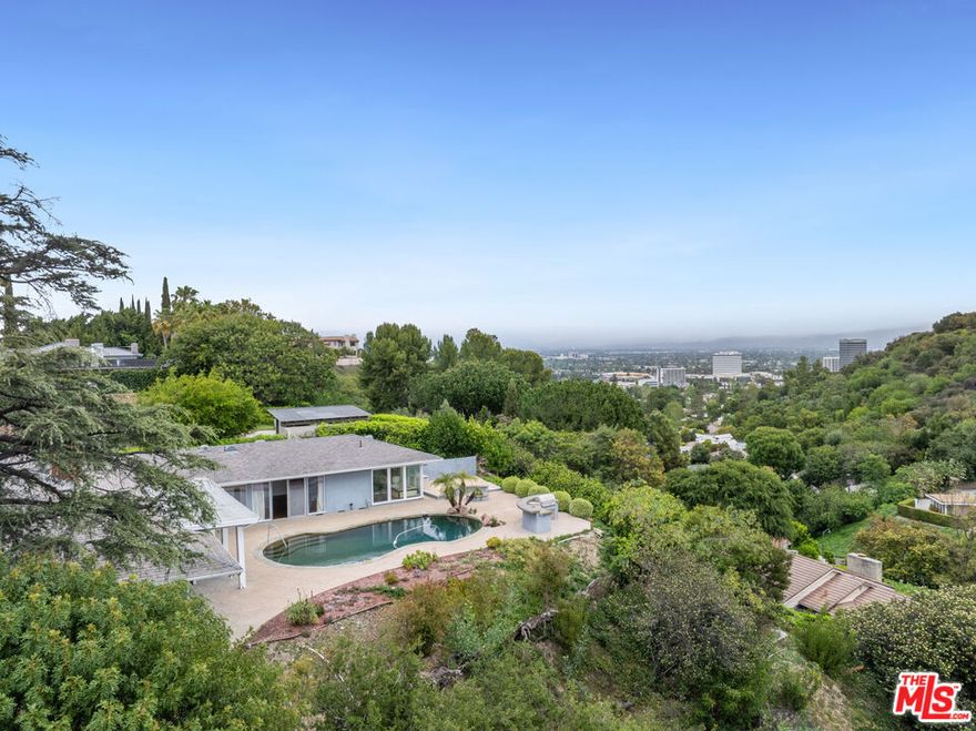 An exceptional opportunity awaits in the prestigious Royal Oaks neighborhood. Located on a quiet cul-de-sac, this single-level mid-century residence is set on an expansive 35,000+ square foot lot with more than 250 feet of frontage. Spanning nearly 3,400 square feet, the home offers 4 spacious bedrooms, a versatile den, 4 baths, and a flowing floor plan that balances casual elegance with everyday comfort. Showcasing authentic mid-century character, the residence features clean architectural lines, walls of glass, and seamless indoor-outdoor integration. Sweeping views of city lights and the surrounding mountains provide a stunning backdrop to both daily living and entertaining. Outdoors, the private grounds invite relaxation and gatherings alike with a pebble-tec pool, built-in BBQ, and fire pit. For those looking ahead, the home offers boundless potentialwhether through a thoughtful restoration, a contemporary reimagining, or the creation of a custom new estate of over 10,700 square feet (buyer to verify). Surrounded by significant properties that have sold between $10 and $20 million, this is more than a residence; it is a rare legacy opportunity in one of Southern California's most coveted enclaves.
